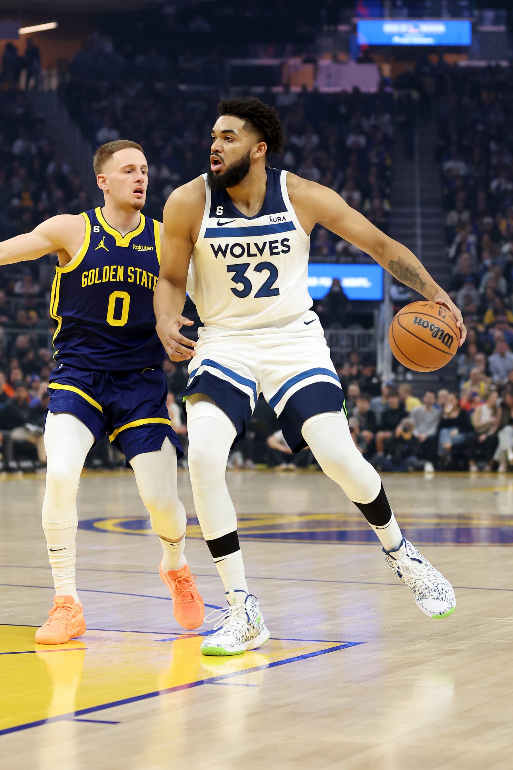 SAN FRANCISCO, CALIFORNIA - MARCH 26: Karl-Anthony Towns #32 of the Minnesota Timberwolves is guarded by Donte DiVincenzo #0 of the Golden State Warriors at Chase Center on March 26, 2023 in San Francisco, California. NOTE TO USER: User expressly acknowledges and agrees that, by downloading and or using this photograph, User is consenting to the terms and conditions of the Getty Images License Agreement.  (Photo by Ezra Shaw/Getty Images)