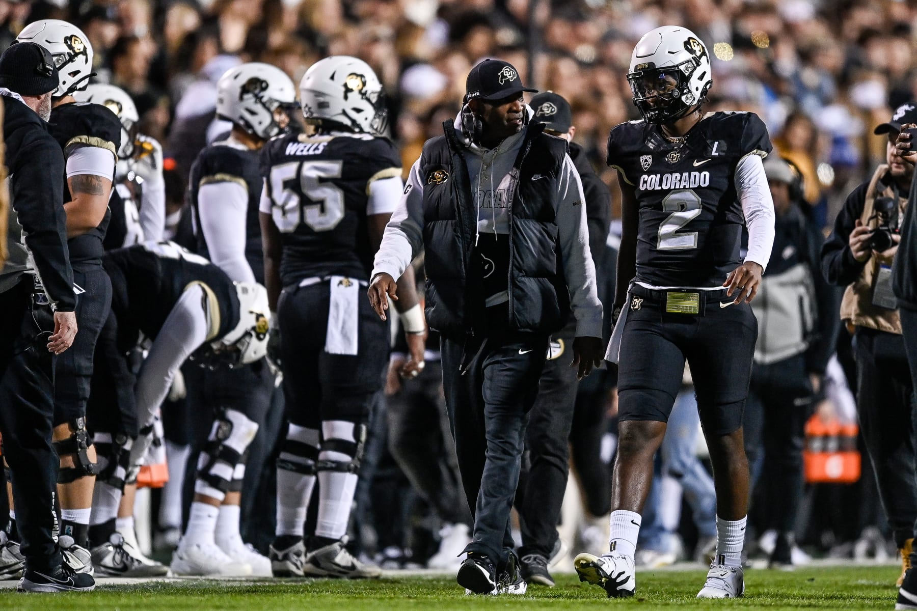 BOULDER, CO - NOVEMBER 4:  Head coach Deion Sanders of the Colorado Buffaloes has a word with quarterback Shedeur Sanders #2 before his first offensive drive in the first half of a game against the Oregon State Beavers at Folsom Field on November 4, 2023 in Boulder, Colorado. (Photo by Dustin Bradford/Getty Images)