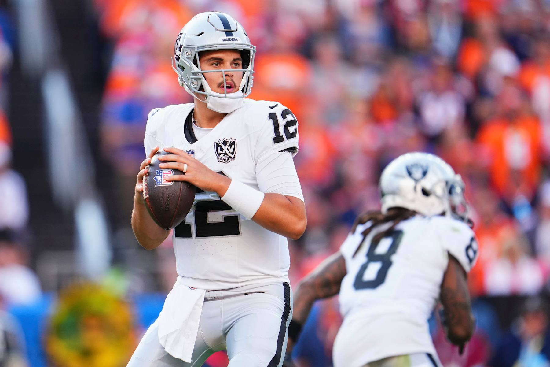 DENVER, CO - OCTOBER 06: Aidan O'Connell #12 of the Las Vegas Raiders drops back to pass against the Denver Broncos during the second half of an NFL football game at Empower Field at Mile High on October 6, 2024 in Denver, Colorado. (Photo by Cooper Neill/Getty Images)