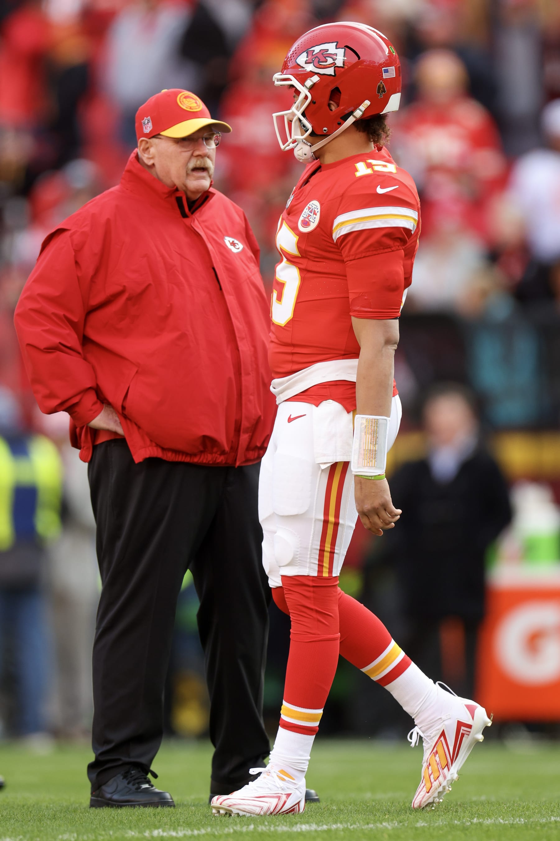 KANSAS CITY, MISSOURI - DECEMBER 10: Patrick Mahomes #15 of the Kansas City Chiefs talks with head coach Andy Reid before the game against the Buffalo Bills at GEHA Field at Arrowhead Stadium on December 10, 2023 in Kansas City, Missouri. (Photo by Jamie Squire/Getty Images)