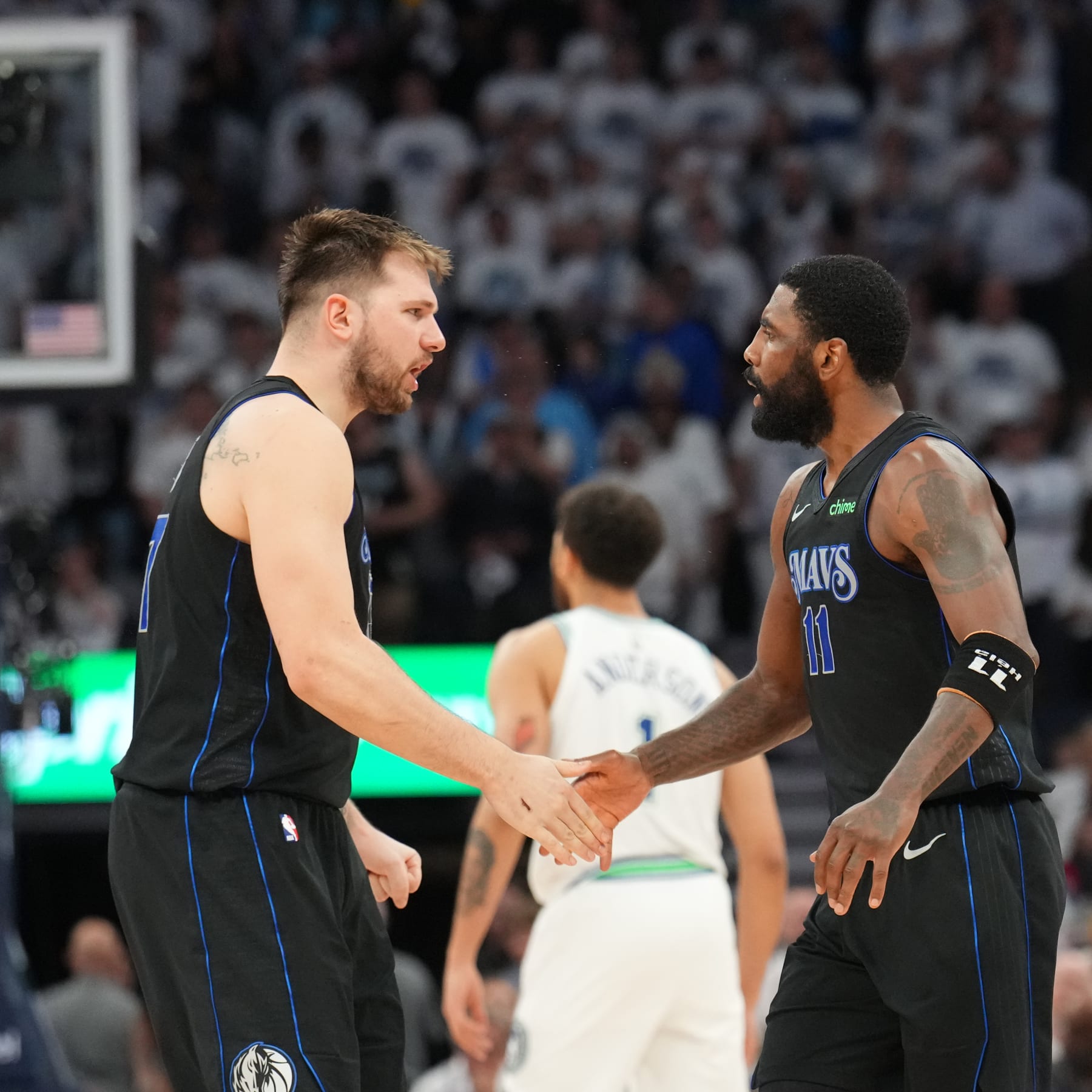 MINNEAPOLIS, MN -  MAY 24: Luka Doncic #77 and Kyrie Irving #11 of the Dallas Mavericks celebrates during the game against the Minnesota Timberwolves during Game 2 of the Western Conference Finals of the 2024 NBA Playoffs on February 24, 2024 at Target Center in Minneapolis, Minnesota. NOTE TO USER: User expressly acknowledges and agrees that, by downloading and or using this Photograph, user is consenting to the terms and conditions of the Getty Images License Agreement. Mandatory Copyright Notice: Copyright 2024 NBAE (Photo by Jesse D. Garrabrant/NBAE via Getty Images)