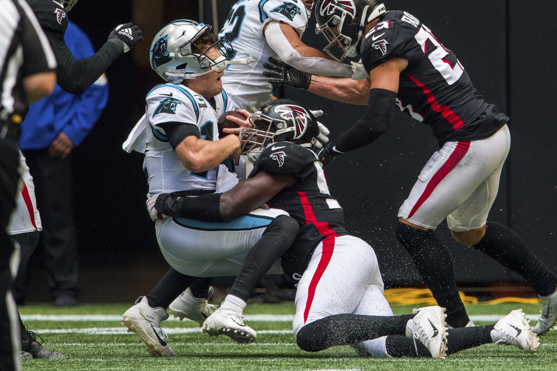 Atlanta Falcons linebacker Foye Oluokun (54) hits Carolina Panthers quarterback Sam Darnold (14) during the second half of an NFL football game, Sunday, Oct. 31, 2021, in Atlanta. The Carolina Panthers won 19-13. (AP Photo/Danny Karnik)