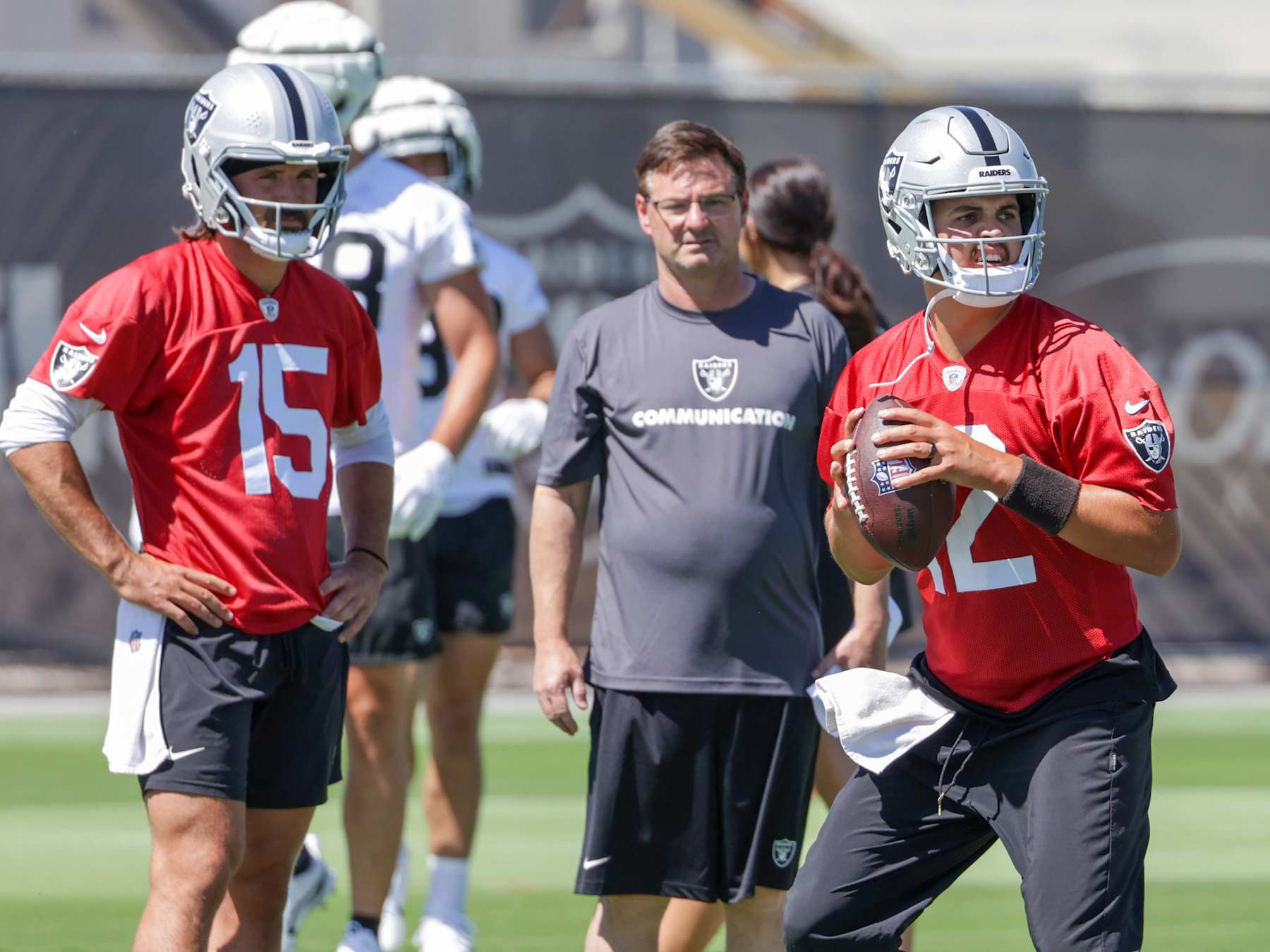HENDERSON, NEVADA - JUNE 04: Quarterback Gardner Minshew #15 and quarterbacks coach Rich Scangarello of the Las Vegas Raiders watch as quarterback Aidan O'Connell #12 throws during an OTA offseason workout at the Las Vegas Raiders Headquarters/Intermountain Healthcare Performance Center on June 04, 2024 in Henderson, Nevada. (Photo by Ethan Miller/Getty Images)