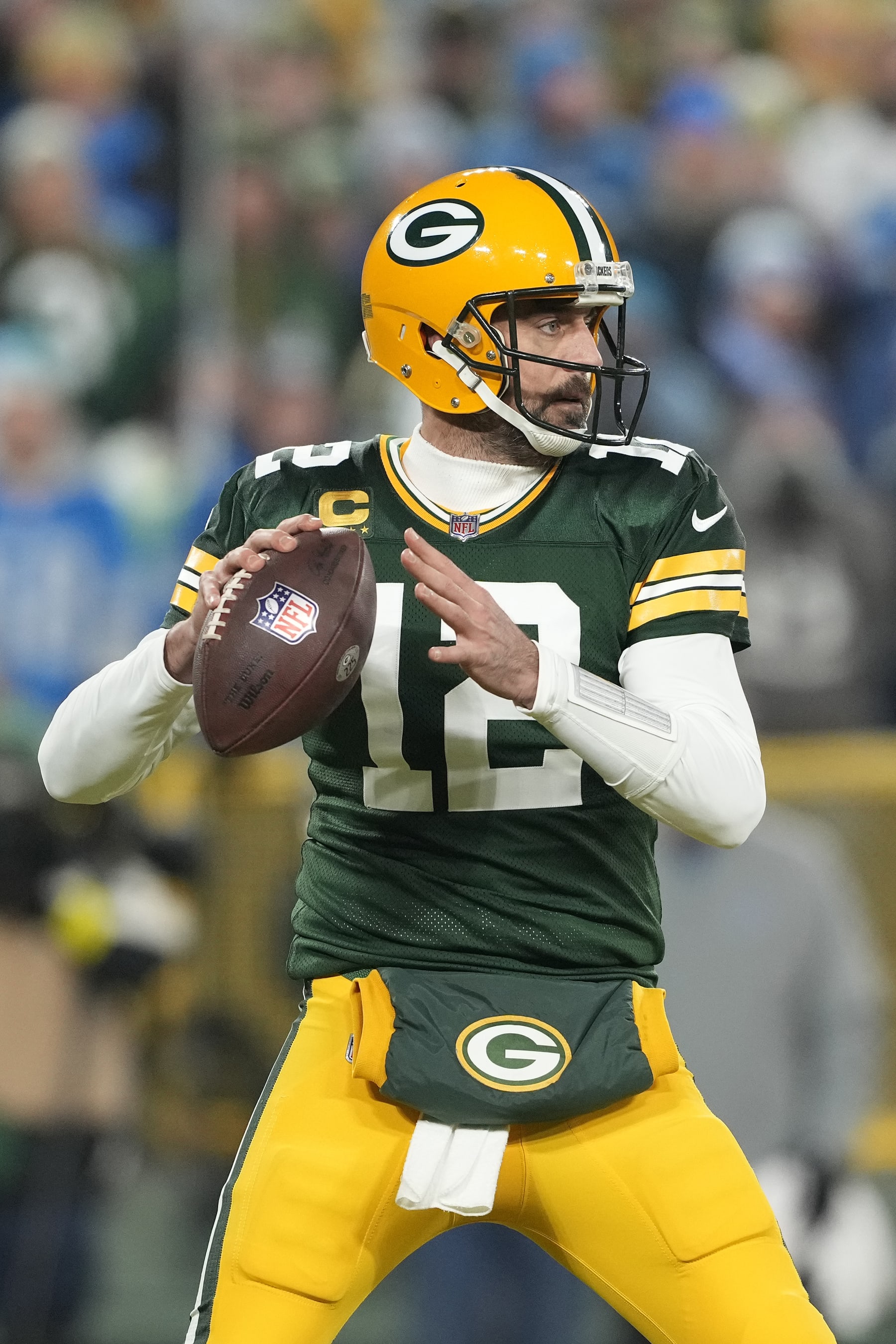 GREEN BAY, WISCONSIN - JANUARY 08: Aaron Rodgers #12 of the Green Bay Packers throws a pass against the Detroit Lions during the first half at Lambeau Field on January 08, 2023 in Green Bay, Wisconsin. (Photo by Patrick McDermott/Getty Images)