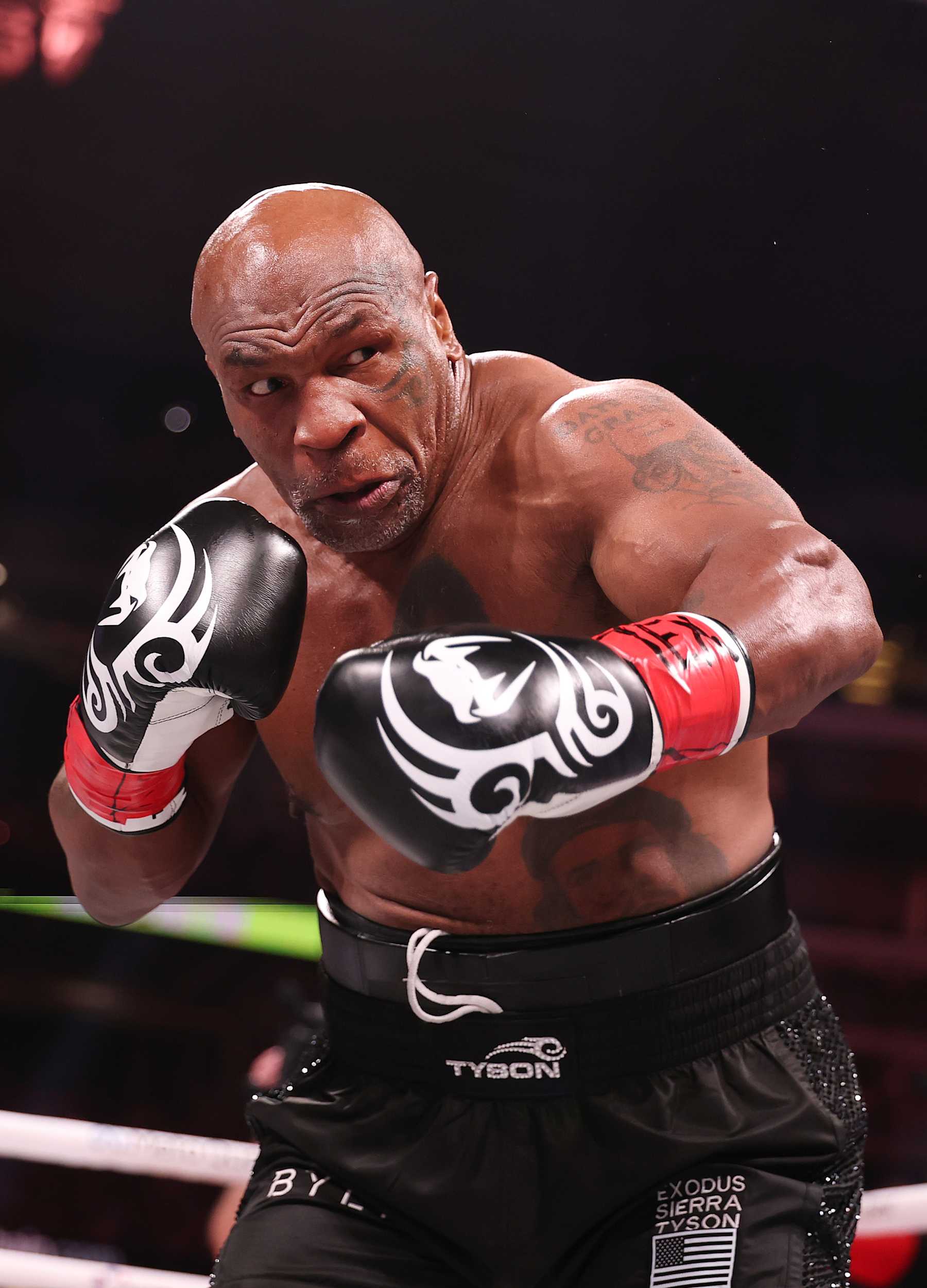 ARLINGTON, TEXAS - NOVEMBER 15:  Mike Tyson in action against Jake Paul during LIVE On Netflix: Jake Paul vs. Mike Tyson at AT&T Stadium on November 15, 2024 in Arlington, Texas.   (Photo by Al Bello/Getty Images for Netflix © 2024)