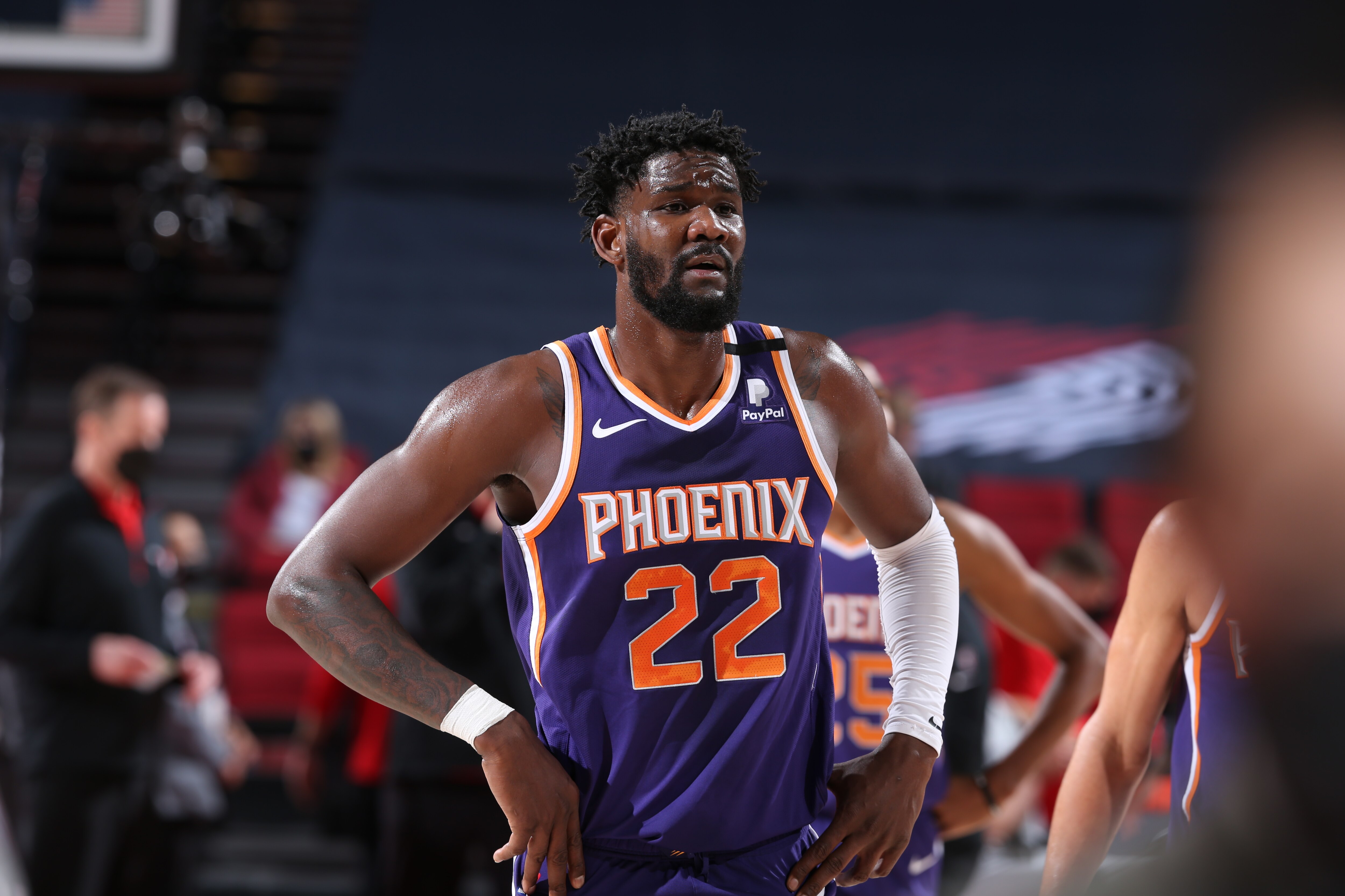 PORTLAND, OR - MARCH 11: Deandre Ayton #22 of the Phoenix Suns looks on during the game against the Portland Trail Blazers on March 11, 2021 at the Moda Center Arena in Portland, Oregon. NOTE TO USER: User expressly acknowledges and agrees that, by downloading and or using this photograph, user is consenting to the terms and conditions of the Getty Images License Agreement. Mandatory Copyright Notice: Copyright 2021 NBAE (Photo by Sam Forencich/NBAE via Getty Images)
