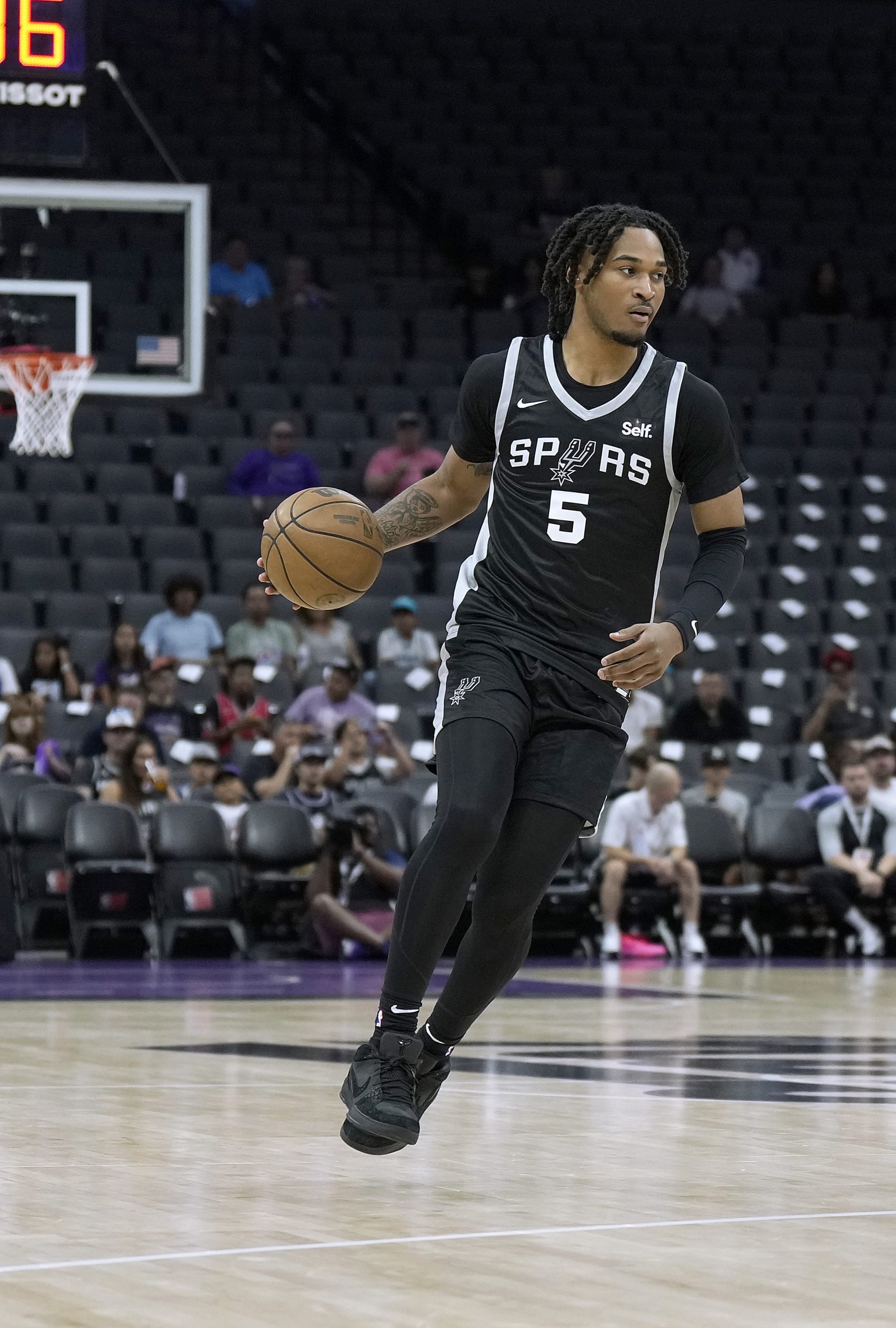 SACRAMENTO, CALIFORNIA - JULY 09: Stephon Castle #5 of the San Antonio Spurs dribbles the ball up court against Team China during the first half of the 2024 California Classic summer league game at Golden 1 Center on July 09, 2024 in Sacramento, California. NOTE TO USER: User expressly acknowledges and agrees that, by downloading and or using this photograph, User is consenting to the terms and conditions of the Getty Images License Agreement. (Photo by Thearon W. Henderson/Getty Images)
