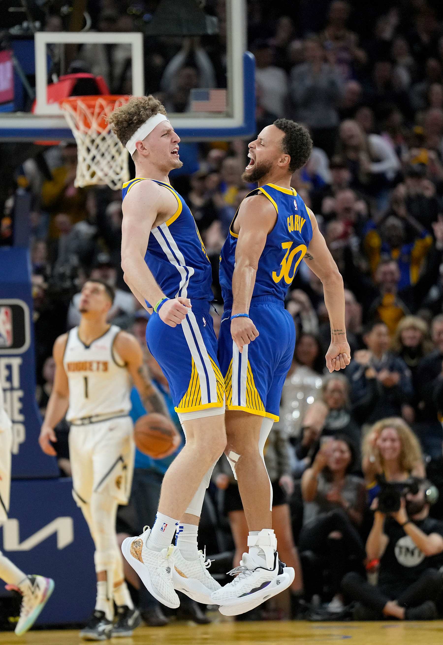 SAN FRANCISCO, CALIFORNIA - JANUARY 04: Brandin Podziemski #2 and Stephen Curry #30 of the Golden State Warriors celebrates after Podziemski steals the ball and scores on a fast-break layup against the Denver Nuggets during the fourth quarter at Chase Center on January 04, 2024 in San Francisco, California. NOTE TO USER: User expressly acknowledges and agrees that, by downloading and or using this photograph, User is consenting to the terms and conditions of the Getty Images License Agreement. (Photo by Thearon W. Henderson/Getty Images)