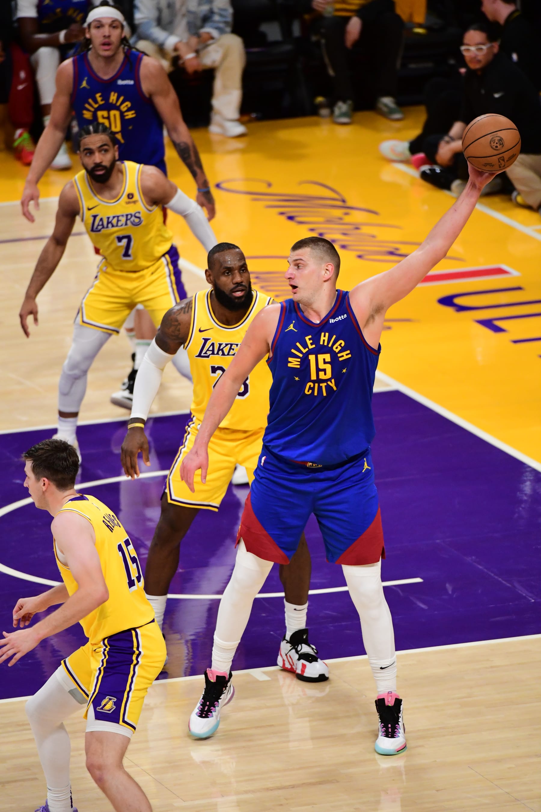 LOS ANGELES, CA - APRIL 25: Nikola Jokic #15 of the Denver Nuggets handles the ball while LeBron James #23 of the Los Angeles Lakers plays defense during the game during Round One Game Three of the 2024 NBA Playoffs on April 25, 2024 at Crypto.Com Arena in Los Angeles, California. NOTE TO USER: User expressly acknowledges and agrees that, by downloading and/or using this Photograph, user is consenting to the terms and conditions of the Getty Images License Agreement. Mandatory Copyright Notice: Copyright 2024 NBAE (Photo by Adam Pantozzi/NBAE via Getty Images)