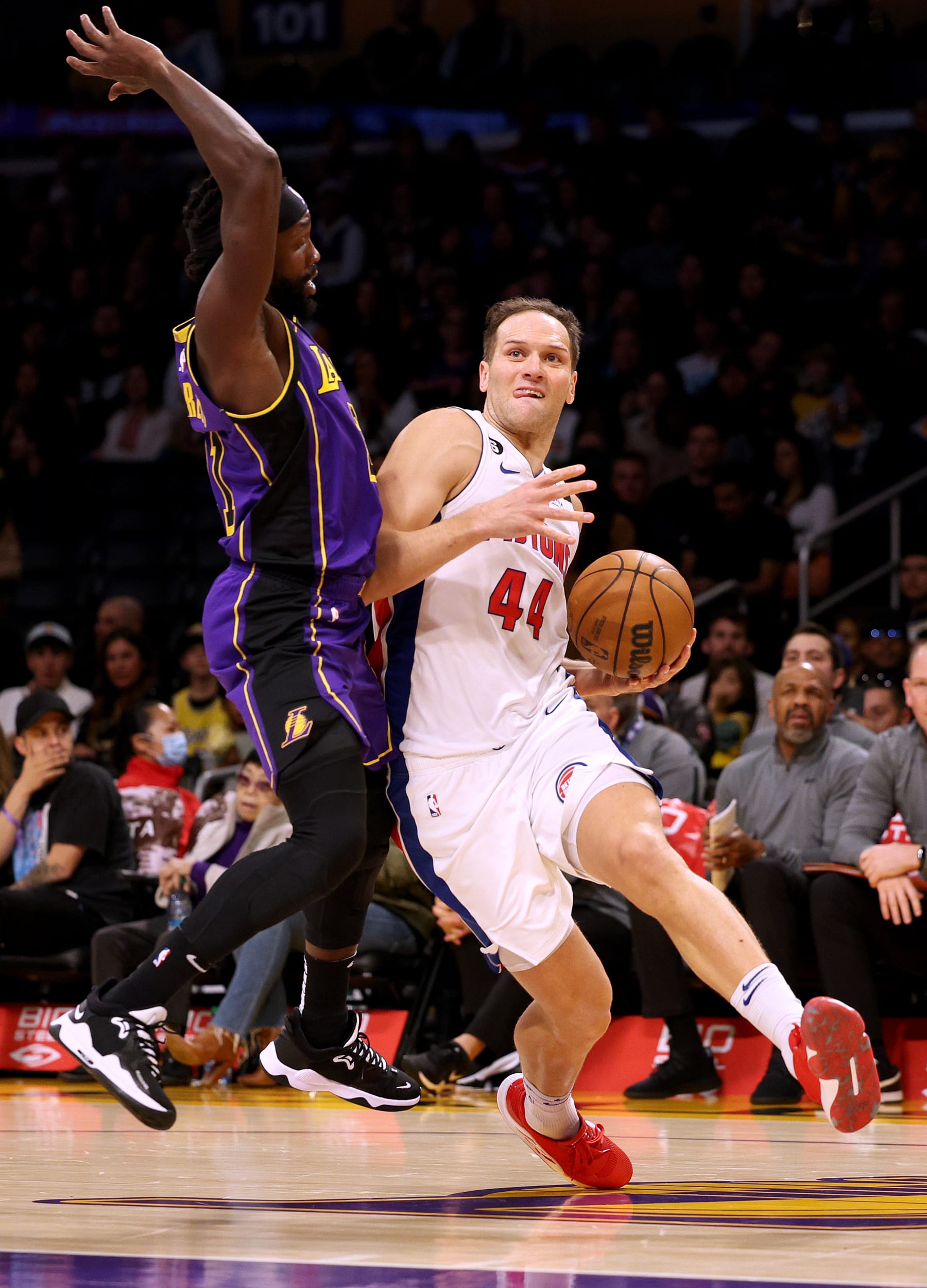 LOS ANGELES, CALIFORNIA - NOVEMBER 18: Bojan Bogdanovic #44 of the Detroit Pistons reacts as he is fouled by Patrick Beverley #21 of the Los Angeles Lakers during the first half at Crypto.com Arena on November 18, 2022 in Los Angeles, California. NOTE TO USER: User expressly acknowledges and agrees that by downloading and/or using this Photograph, user is consenting to the terms and conditions of the Getty Images License Agreement. Mandatory Copyright Notice: Copyright 2022 NBAE. (Photo by Harry How/Getty Images)