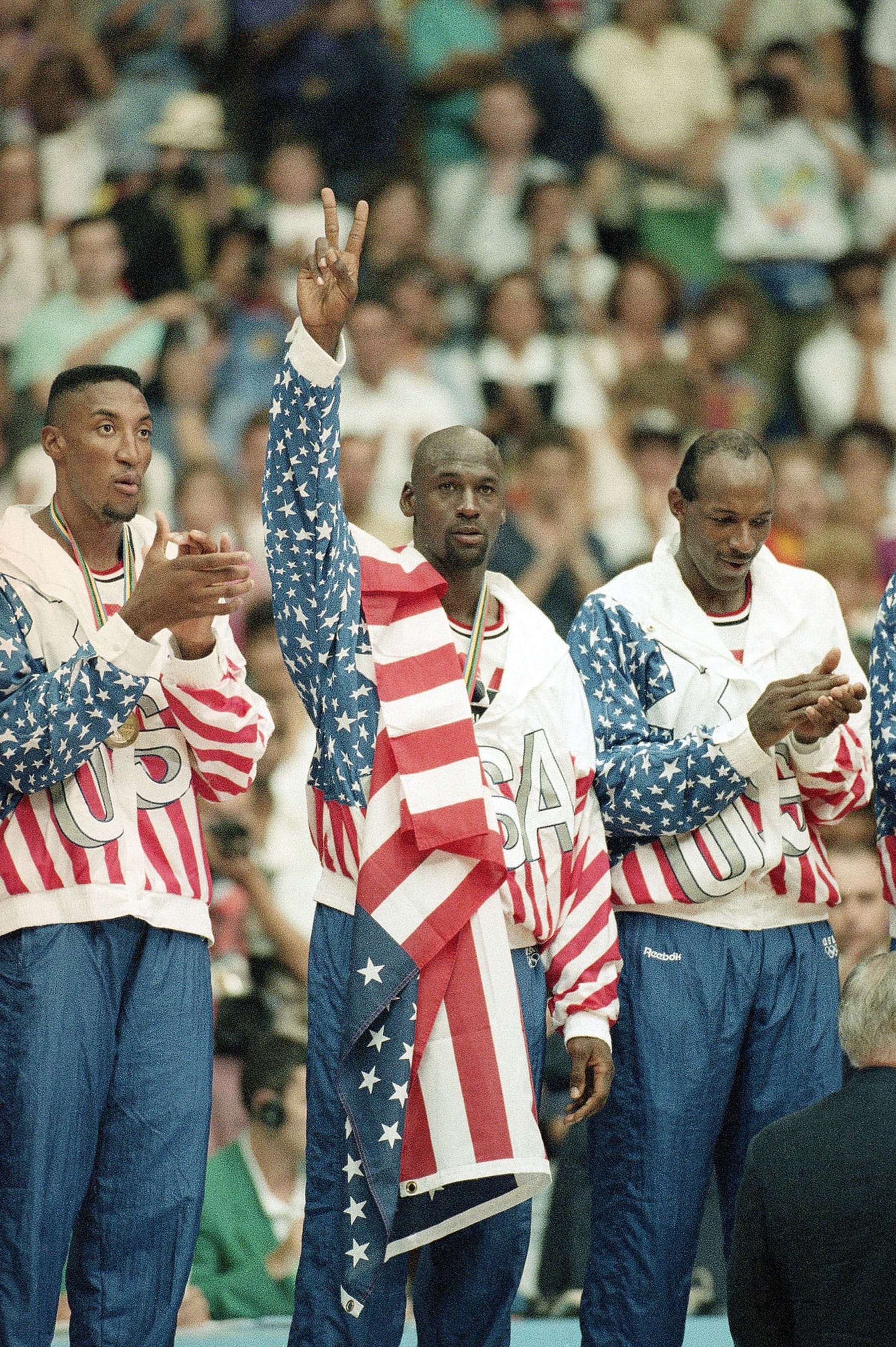 FILE - United States' Scottie Pippen, left, Michael Jorden, center, and Clyde Drexler rejoice, Aug. 8, 1992, with their gold medals after beating Croatia, 117-85, in Olympic basketball in Barcelona, Spain. The jacket that Jordan famously wore but covered the Reebok logo of at the 1992 Barcelona Olympics will be offered at auction by Sotheby's in June 2023. (AP Photo/Susan Ragan, File)