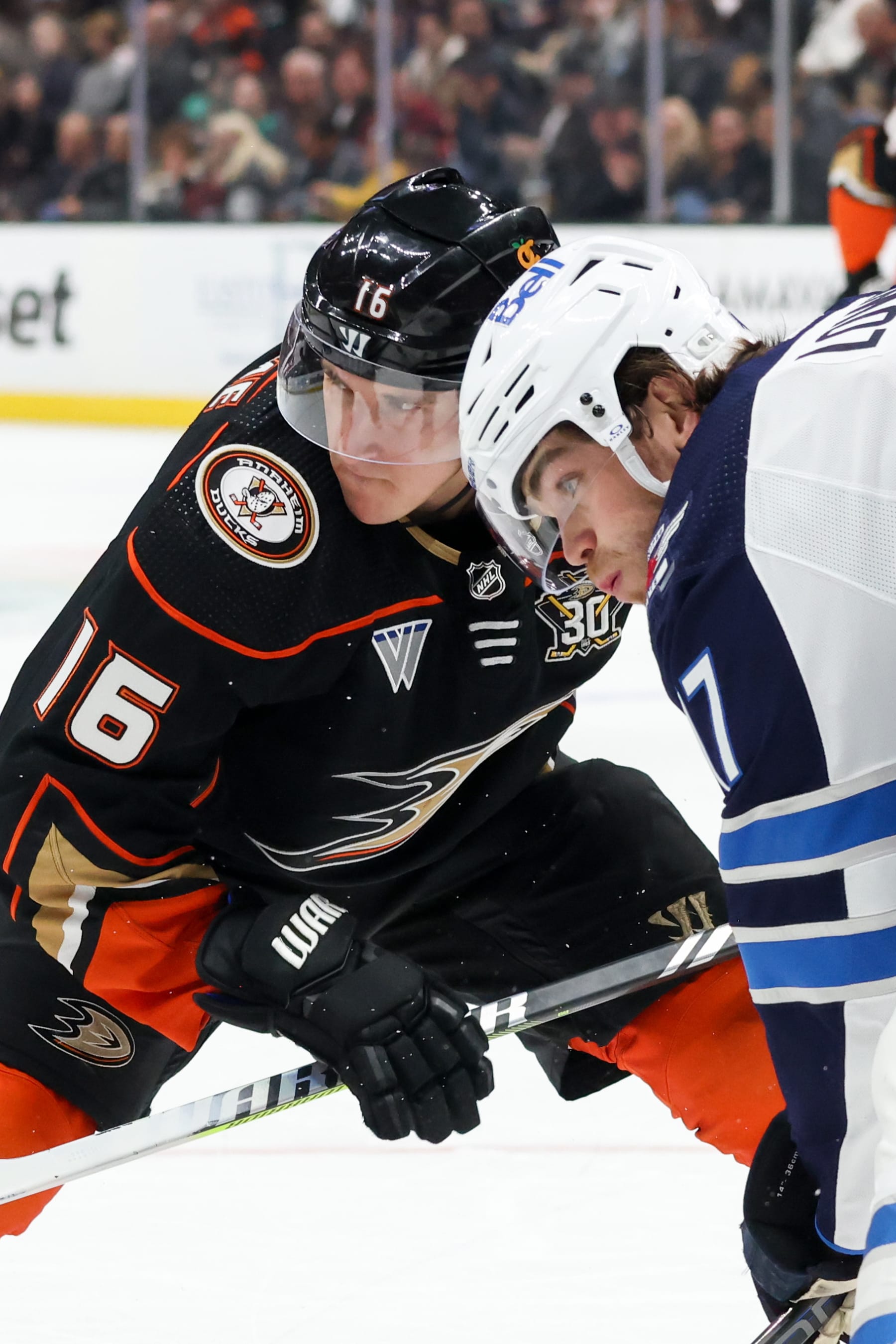 ANAHEIM, CA - DECEMBER 10:  Ryan Strome #16 of the Anaheim Ducks and Adam Lowry #17 of the Winnipeg Jets get ready for the puck drop  during the first period at Honda Center on December 10, 2023 in Anaheim, California. (Photo by Debora Robinson/NHLI via Getty Images)