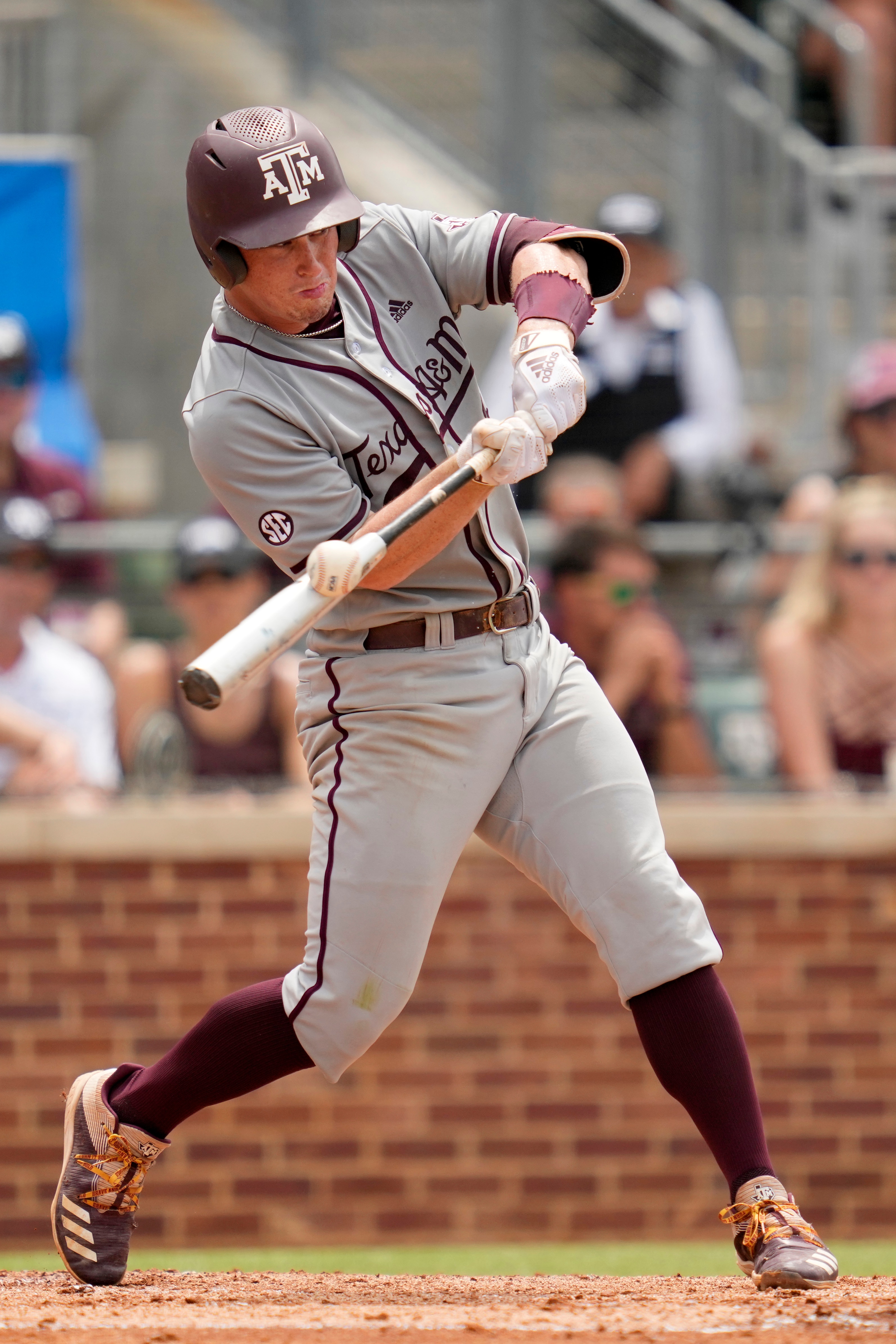 Texas A&M's Ryan Targac makes contact with a pitch against Louisville during an NCAA college baseball super regional tournament game Saturday, June 11, 2022, in College Station, Texas. (AP Photo/Sam Craft)