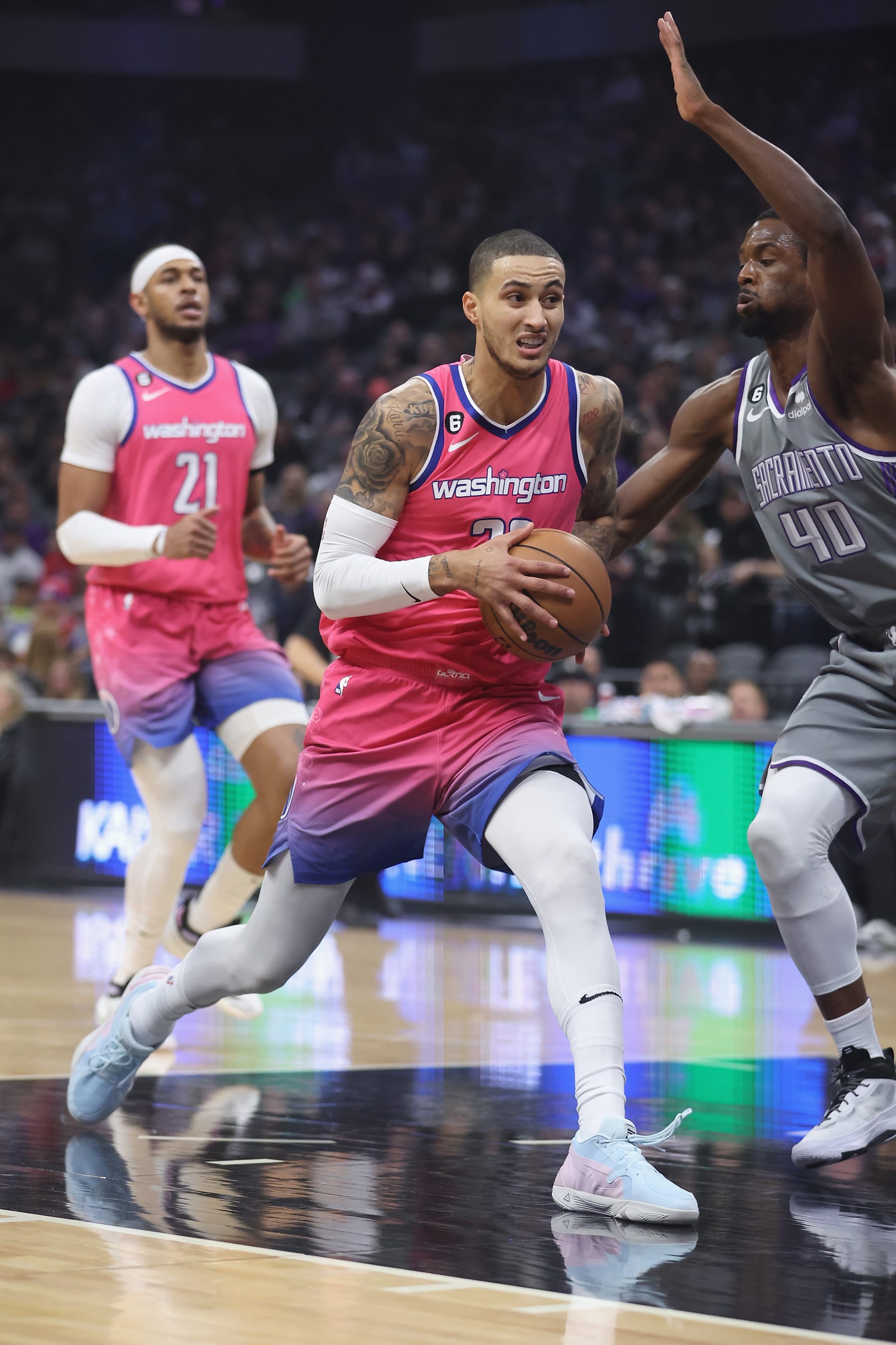 SACRAMENTO, CALIFORNIA - DECEMBER 23: Kyle Kuzma #33 of the Washington Wizards drives to the basket against Harrison Barnes #40 of the Sacramento Kings in the first quarter at Golden 1 Center on December 23, 2022 in Sacramento, California. NOTE TO USER: User expressly acknowledges and agrees that, by downloading and/or using this photograph, User is consenting to the terms and conditions of the Getty Images License Agreement. (Photo by Lachlan Cunningham/Getty Images)