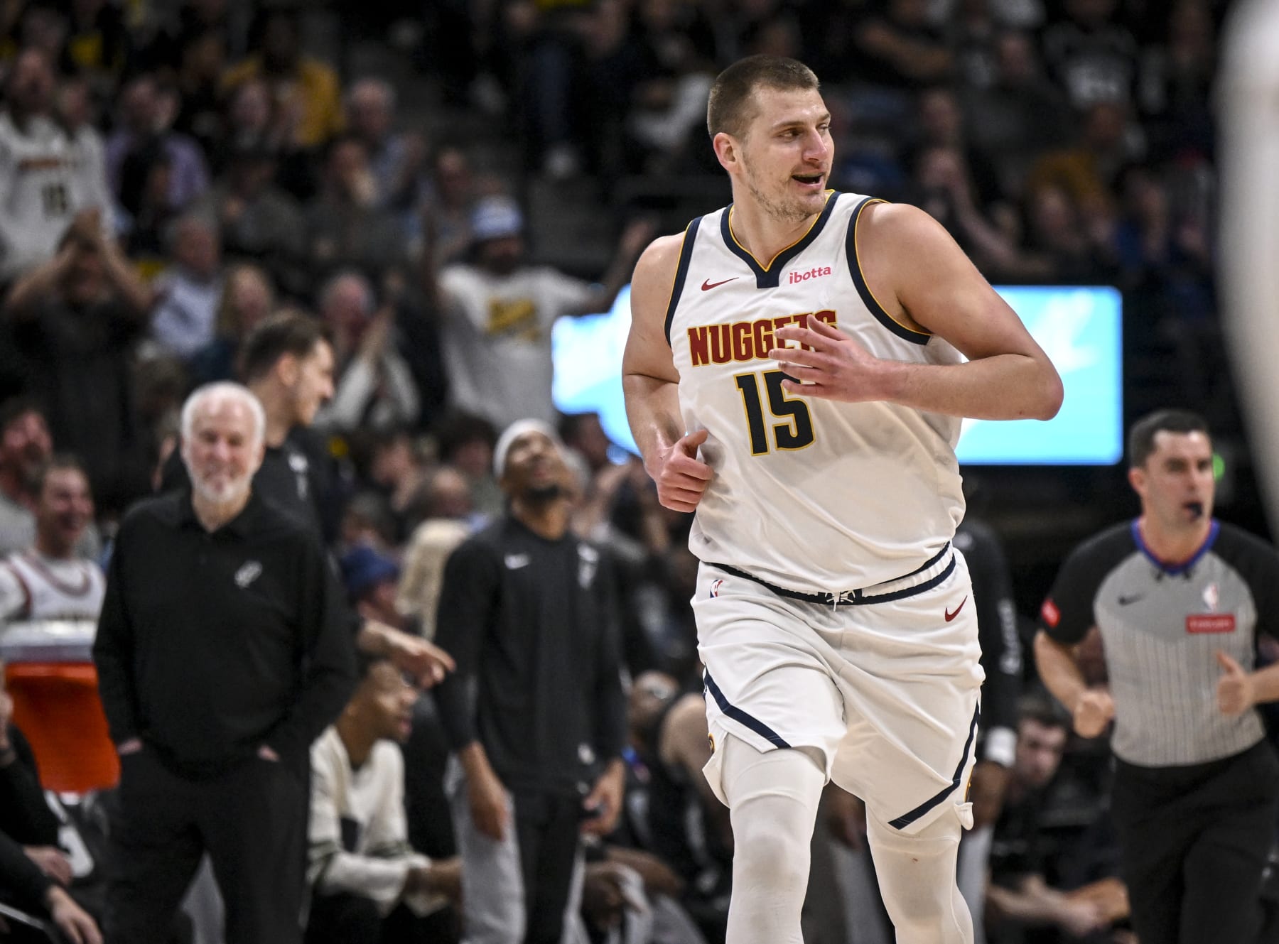 DENVER, CO - APRIL 2: Nikola Jokic (15) of the Denver Nuggets smiles in the direction of Victor Wembanyama (1) of the San Antonio Spurs after dunking on him during the first quarter at Ball Arena in Denver on Tuesday, April 2, 2024. (Photo by AAron Ontiveroz/The Denver Post)