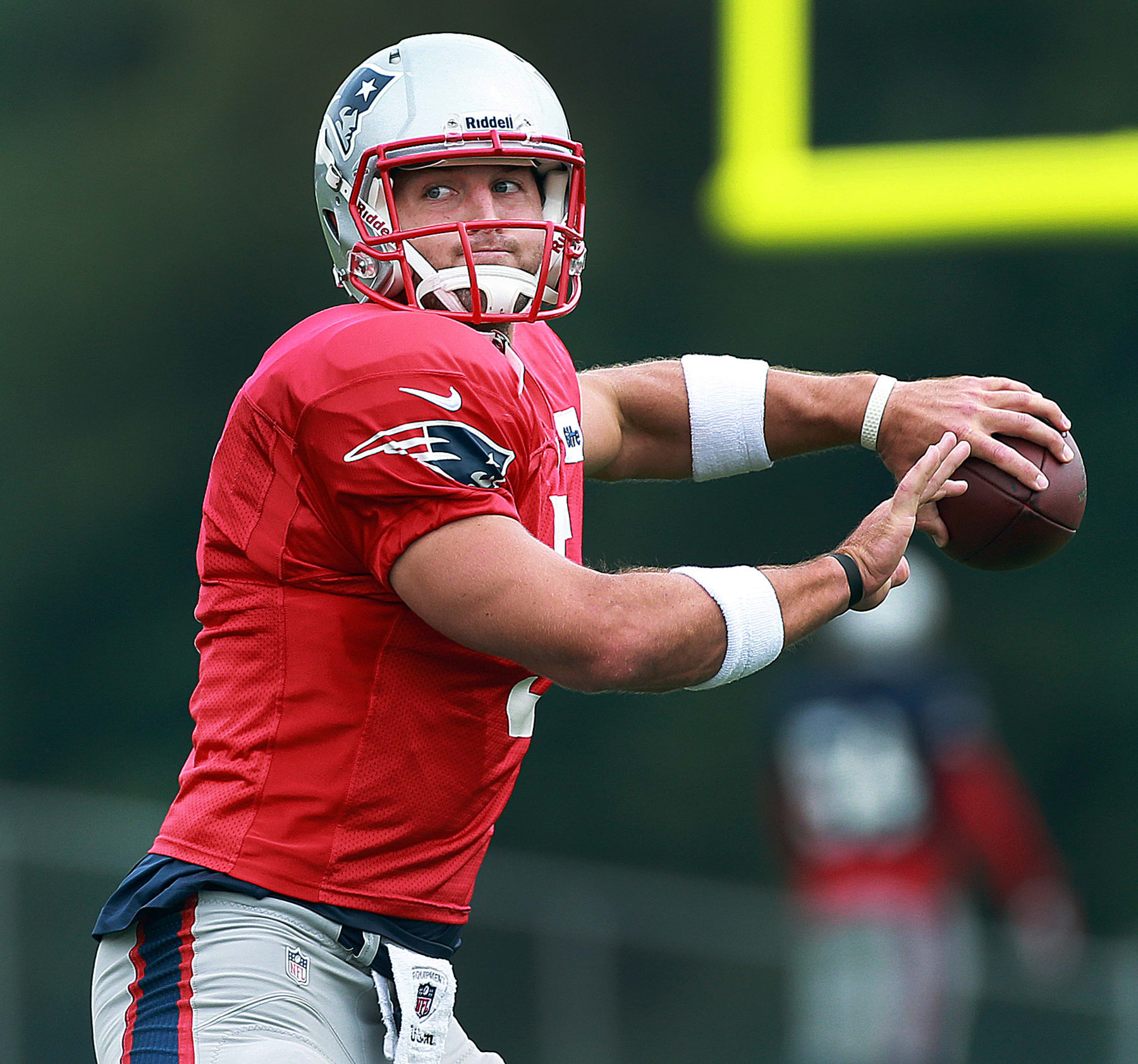 FOXBOROUGH, MA - AUGUST 26: Patriots quarterback Tim Tebow (#5) throws a pass. The New England Patriots held a workout on the practice fields outside of Gillette Stadium this afternoon. (Photo by Jim Davis/The Boston Globe via Getty Images)