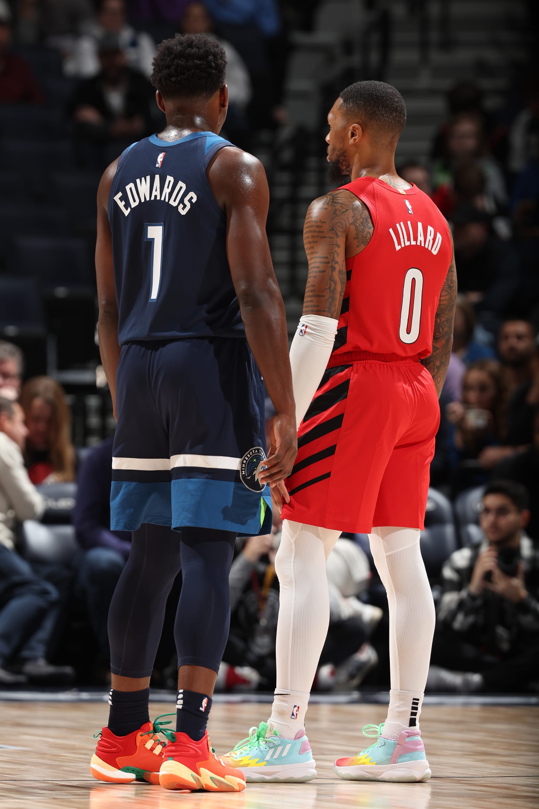 MINNEAPOLIS, MN -  JANUARY 4:  Anthony Edwards #1 of the Minnesota Timberwolves and Damian Lillard #0 of the Portland Trail Blazers looks on during the game on January 4, 2022 at Target Center in Minneapolis, Minnesota. NOTE TO USER: User expressly acknowledges and agrees that, by downloading and or using this Photograph, user is consenting to the terms and conditions of the Getty Images License Agreement. Mandatory Copyright Notice: Copyright 2022 NBAE (Photo by David Sherman/NBAE via Getty Images)