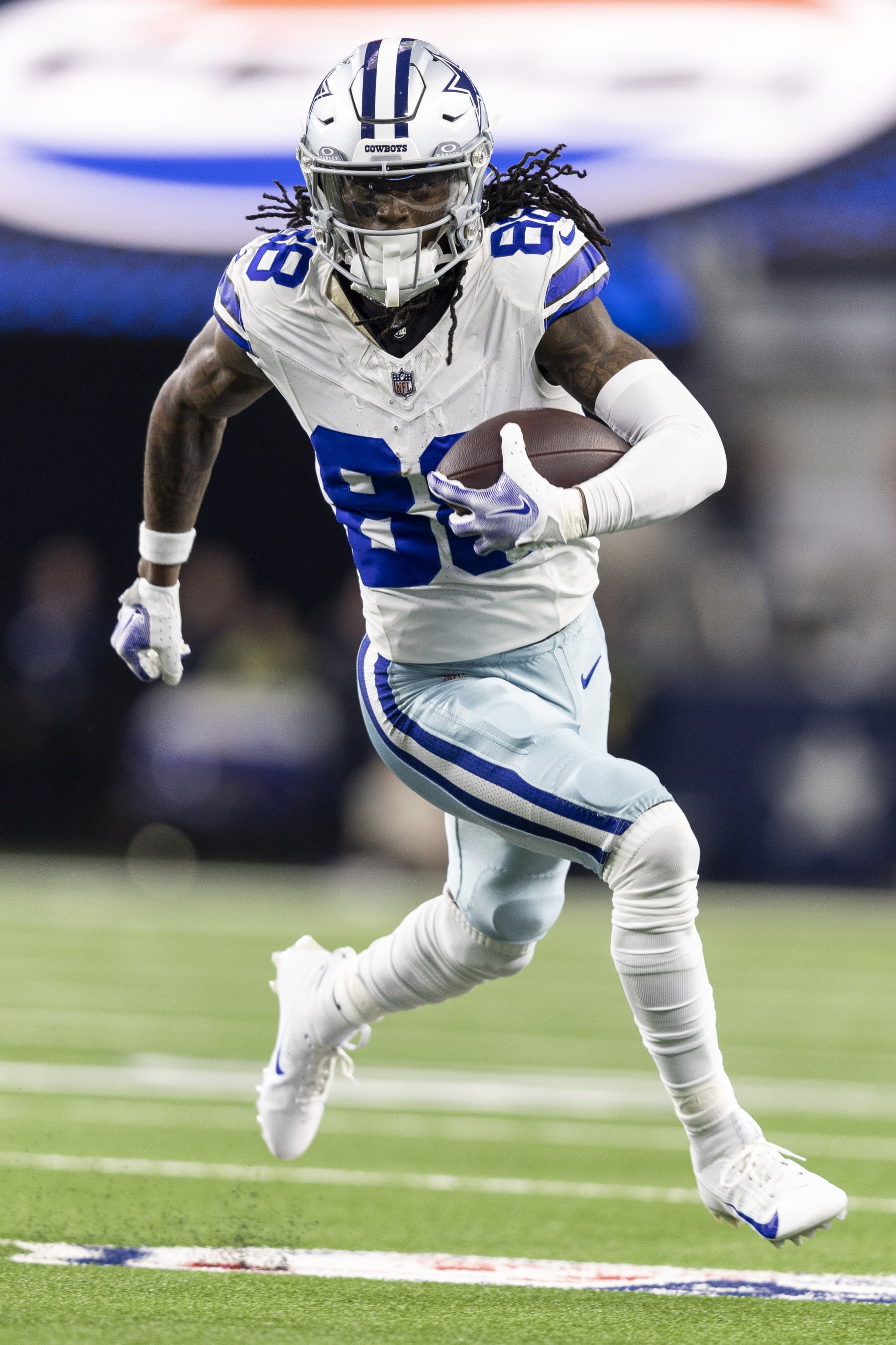 ARLINGTON, TEXAS - NOVEMBER 30: CeeDee Lamb #88 of the Dallas Cowboys runs with the ball during an NFL football game between the Dallas Cowboys and the Seattle Seahawks at AT&T Stadium on November 30, 2023 in Arlington, Texas. (Photo by Michael Owens/Getty Images)
