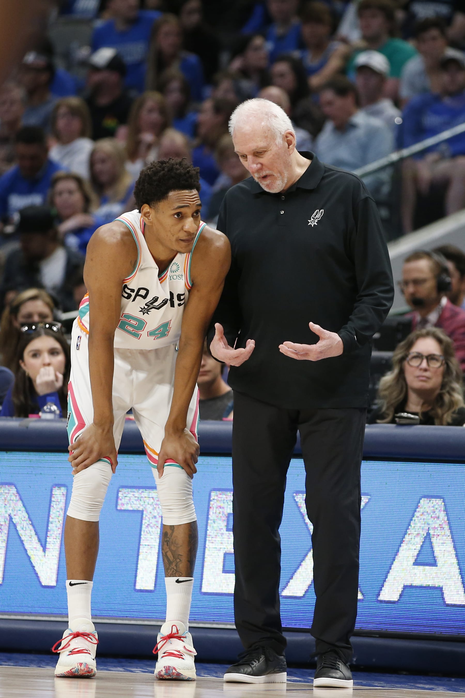 DALLAS, TEXAS - APRIL 10: Devin Vassell #24 of the San Antonio Spurs talks with Gregg Popovich during the game against the Dallas Mavericks at American Airlines Center on April 10, 2022 in Dallas, Texas. NOTE TO USER: User expressly acknowledges and agrees that, by downloading and or using this photograph, User is consenting to the terms and conditions of the Getty Images License Agreement.  (Photo by Tim Heitman/Getty Images)