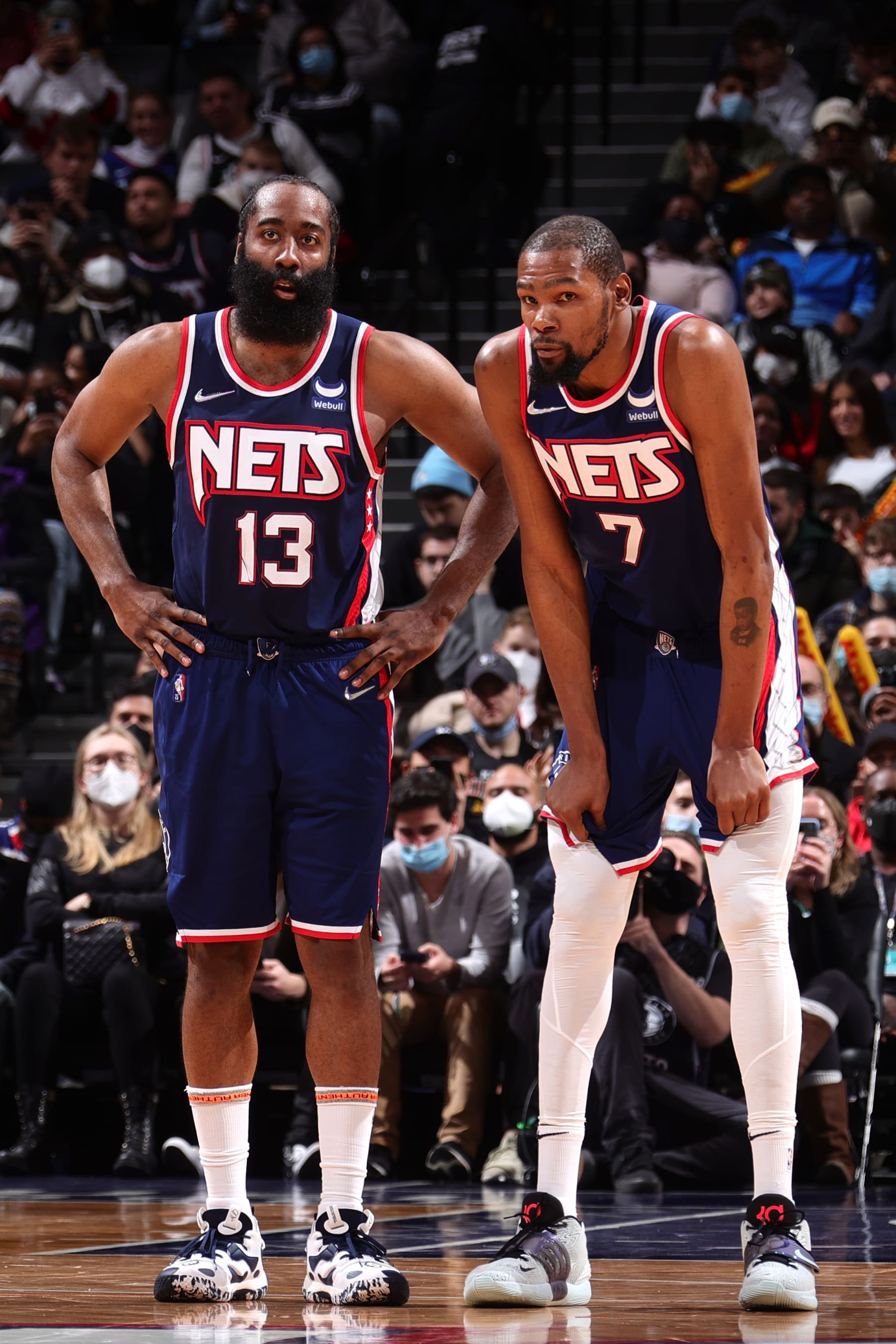 BROOKLYN, NY - JANUARY 1: James Harden #13 and Kevin Durant #7 of the Brooklyn Nets look on during the game against the LA Clippers on January 1, 2022 at Barclays Center in Brooklyn, New York. NOTE TO USER: User expressly acknowledges and agrees that, by downloading and or using this Photograph, user is consenting to the terms and conditions of the Getty Images License Agreement. Mandatory Copyright Notice: Copyright 2021 NBAE (Photo by Nathaniel S. Butler/NBAE via Getty Images)