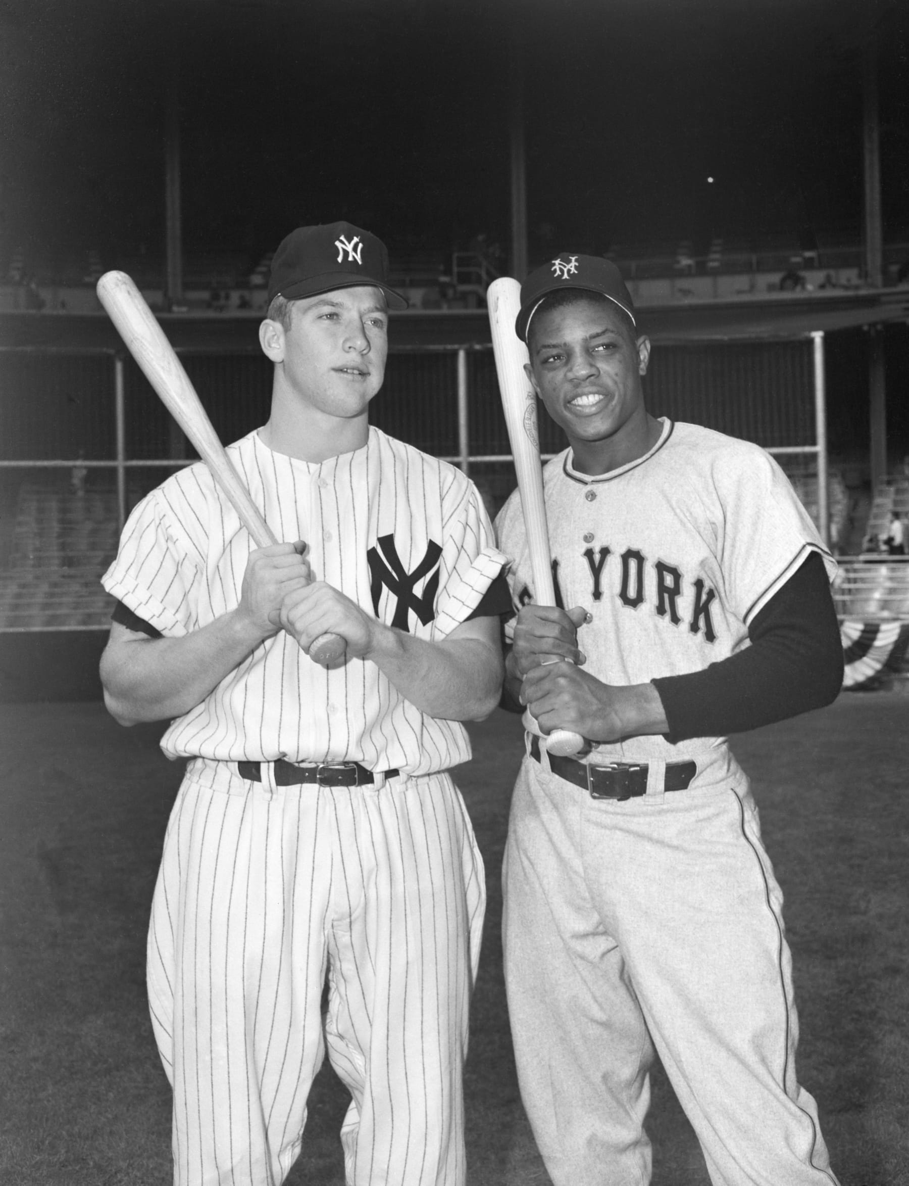 (Original Caption) 1951: Mickey Mantle of the New York Yankees (L), poses with Willie Mays of the New York Giants (R) at Yankee Stadium prior to the World Series.