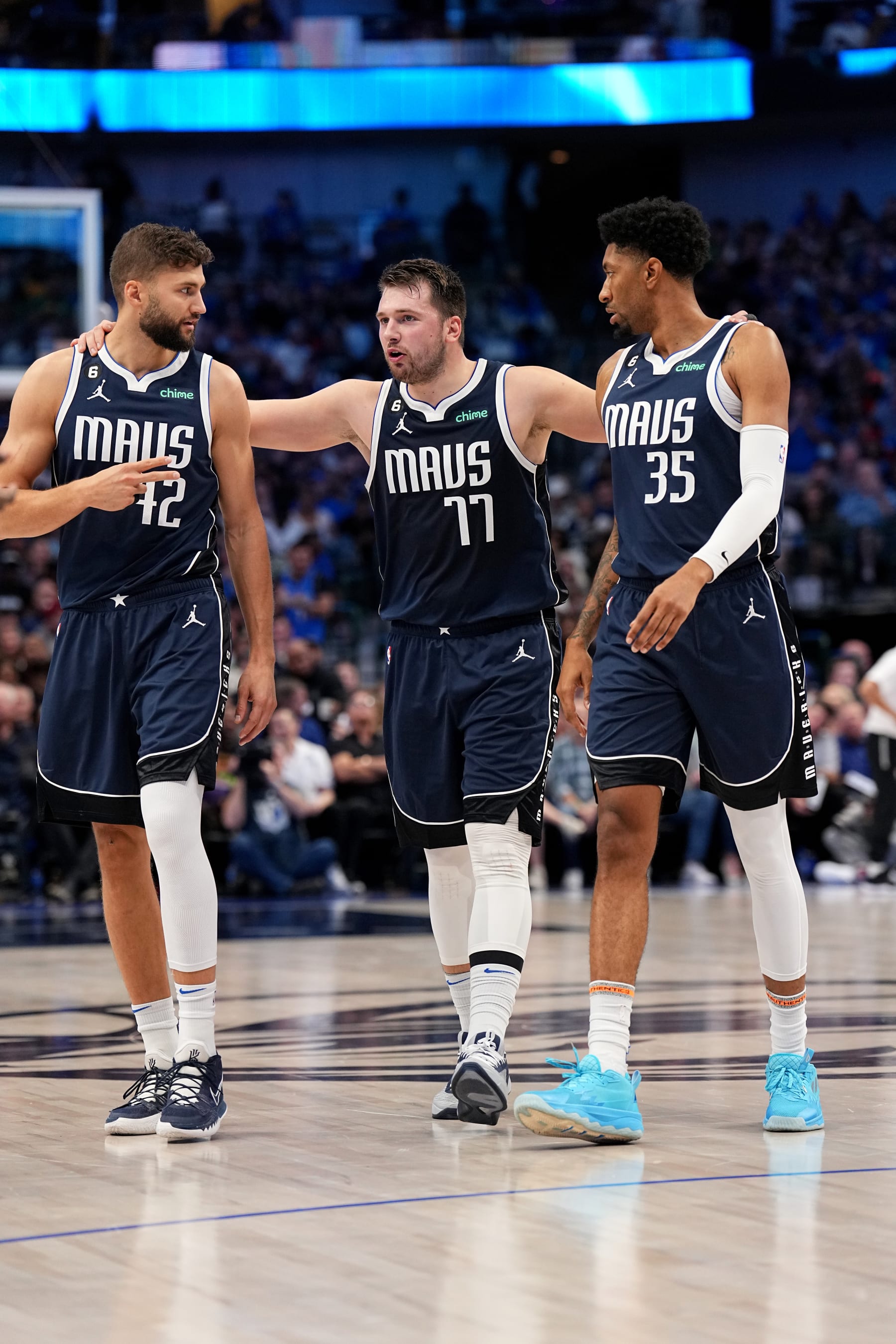 DALLAS, TX - OCTOBER 22: Maxi Kleber #42, Luka Doncic #77, and Christian Wood #35 of the Dallas Mavericks huddle up during the game against the Memphis Grizzlies on October 22, 2022 at the American Airlines Center in Dallas, Texas. NOTE TO USER: User expressly acknowledges and agrees that, by downloading and or using this photograph, User is consenting to the terms and conditions of the Getty Images License Agreement. Mandatory Copyright Notice: Copyright 2022 NBAE (Photo by Glenn James/NBAE via Getty Images)