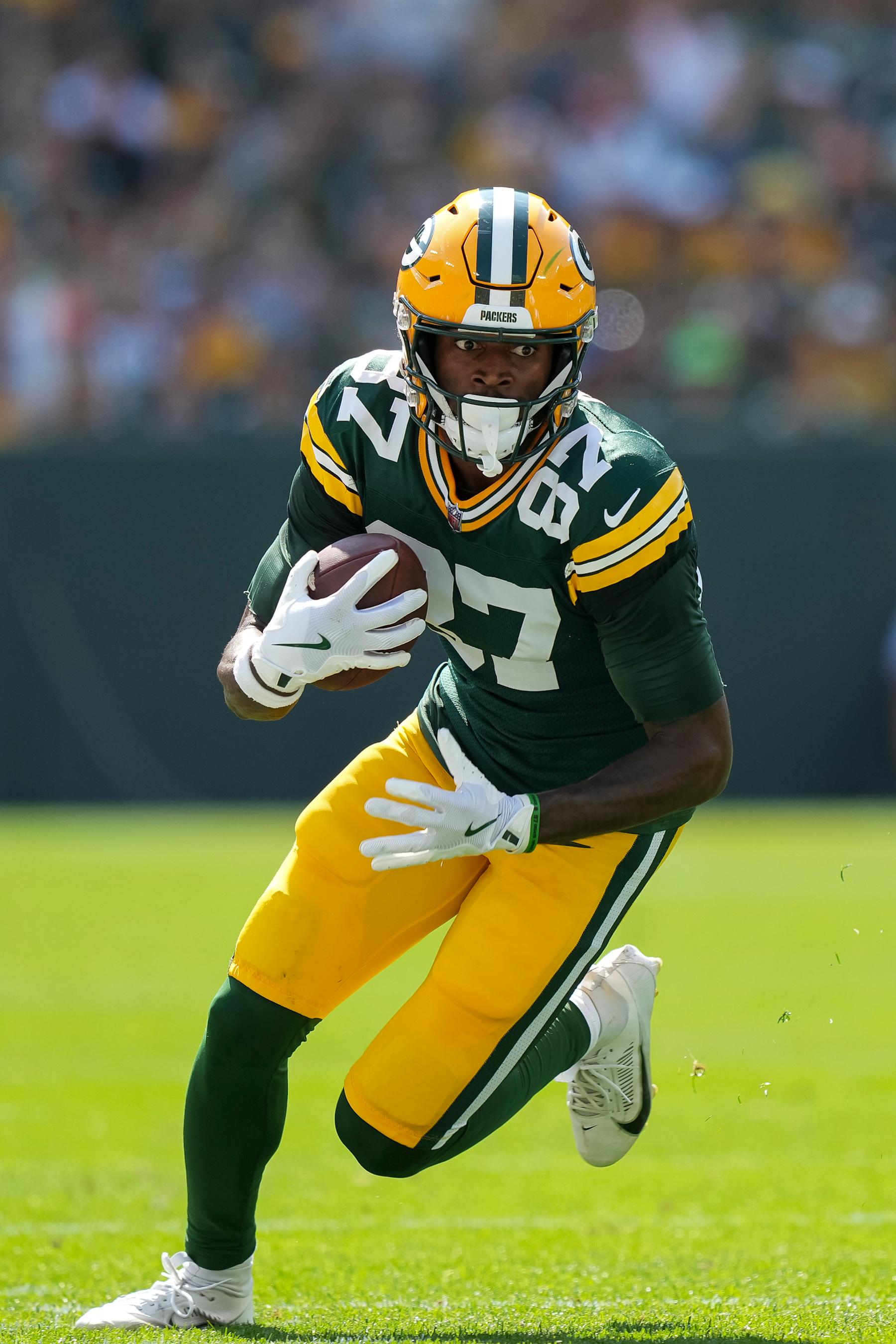 GREEN BAY, WI - SEPTEMBER 15: Wide receiver Romeo Doubs #87 of the Green Bay Packers carries the ball after completing a catch during the first quarter of an NFL football game against the Indianapolis Colts, at Lambeau Field on September 15, 2024 in Green Bay, Wisconsin. (Photo by Todd Rosenberg/Getty Images)