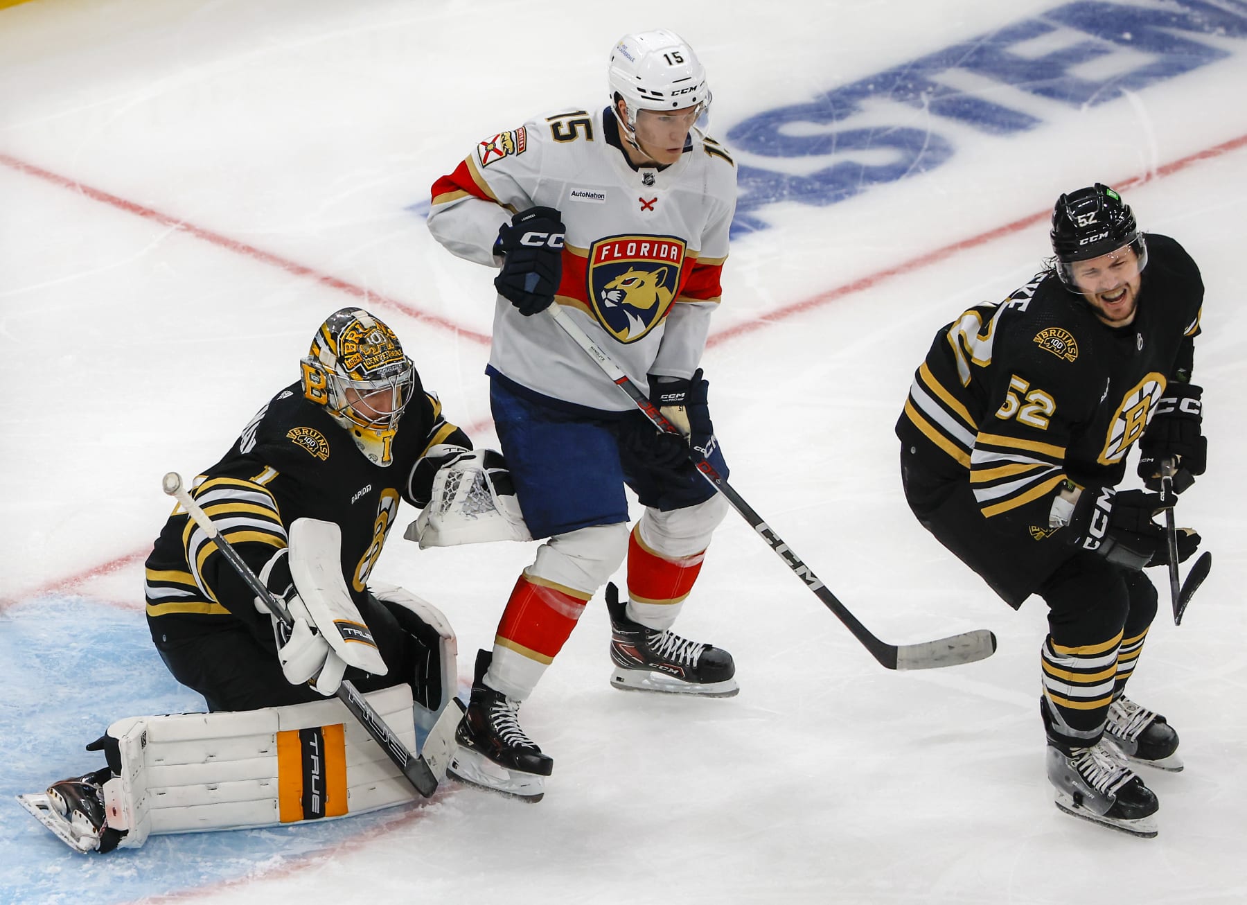 Florida Panthers forward Anton Lundell (standing) and Boston Bruins goaltender Jeremy Swayman. 