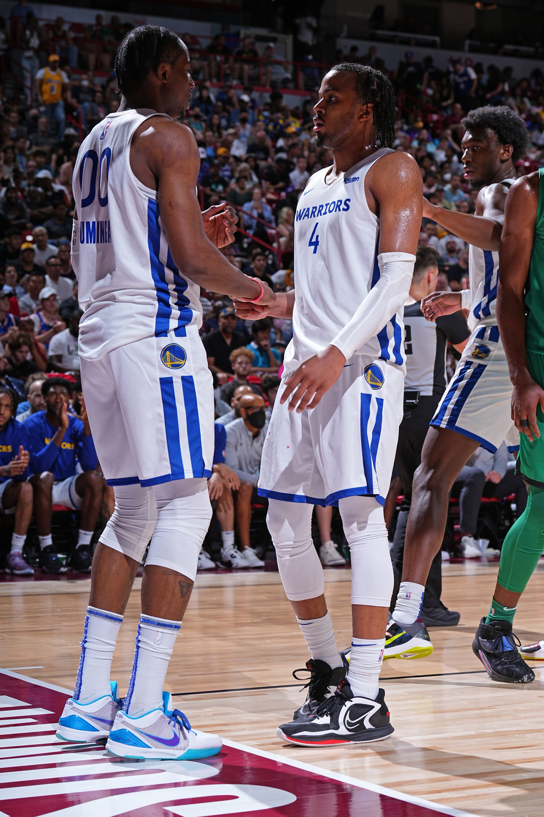 LAS VEGAS, NV - JULY 12: Jonathan Kuminga #00 talks to  Moses Moody #4 of the Golden State Warriors after the game against the Boston Celtics during the 2022 Las Vegas Summer League on July 12, 2022 at the Thomas & Mack Center in Las Vegas, Nevada NOTE TO USER: User expressly acknowledges and agrees that, by downloading and/or using this Photograph, user is consenting to the terms and conditions of the Getty Images License Agreement. Mandatory Copyright Notice: Copyright 2022 NBAE (Photo by Garrett Ellwood/NBAE via Getty Images)