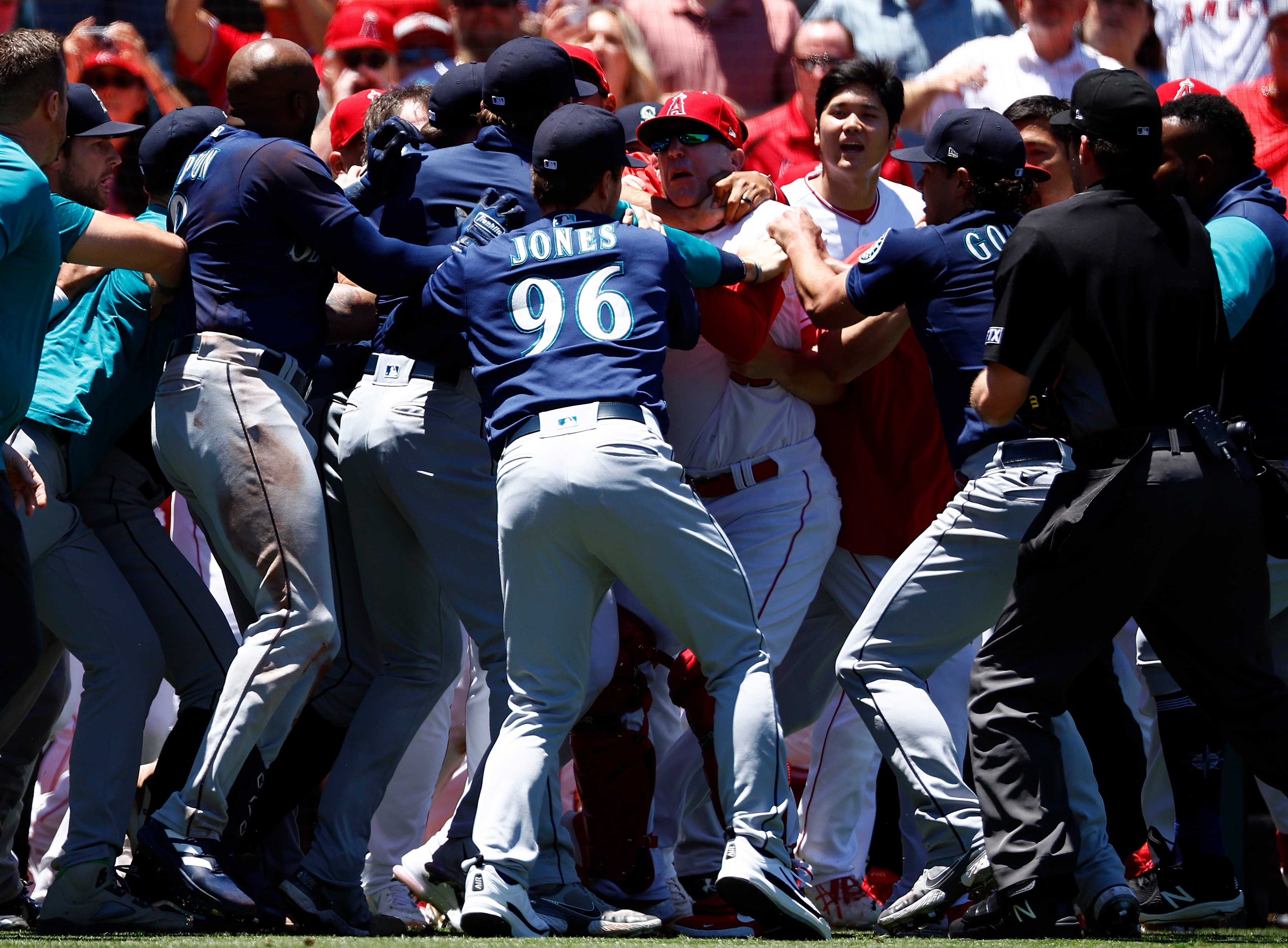 ANAHEIM, CALIFORNIA - JUNE 26:   The Seattle Mariners and the Los Angeles Angels clear the benches after Jesse Winker #27 of the Seattle Mariners charged the Angels dugout after being hit by a pitch in the second inning at Angel Stadium of Anaheim on June 26, 2022 in Anaheim, California. (Photo by Ronald Martinez/Getty Images)