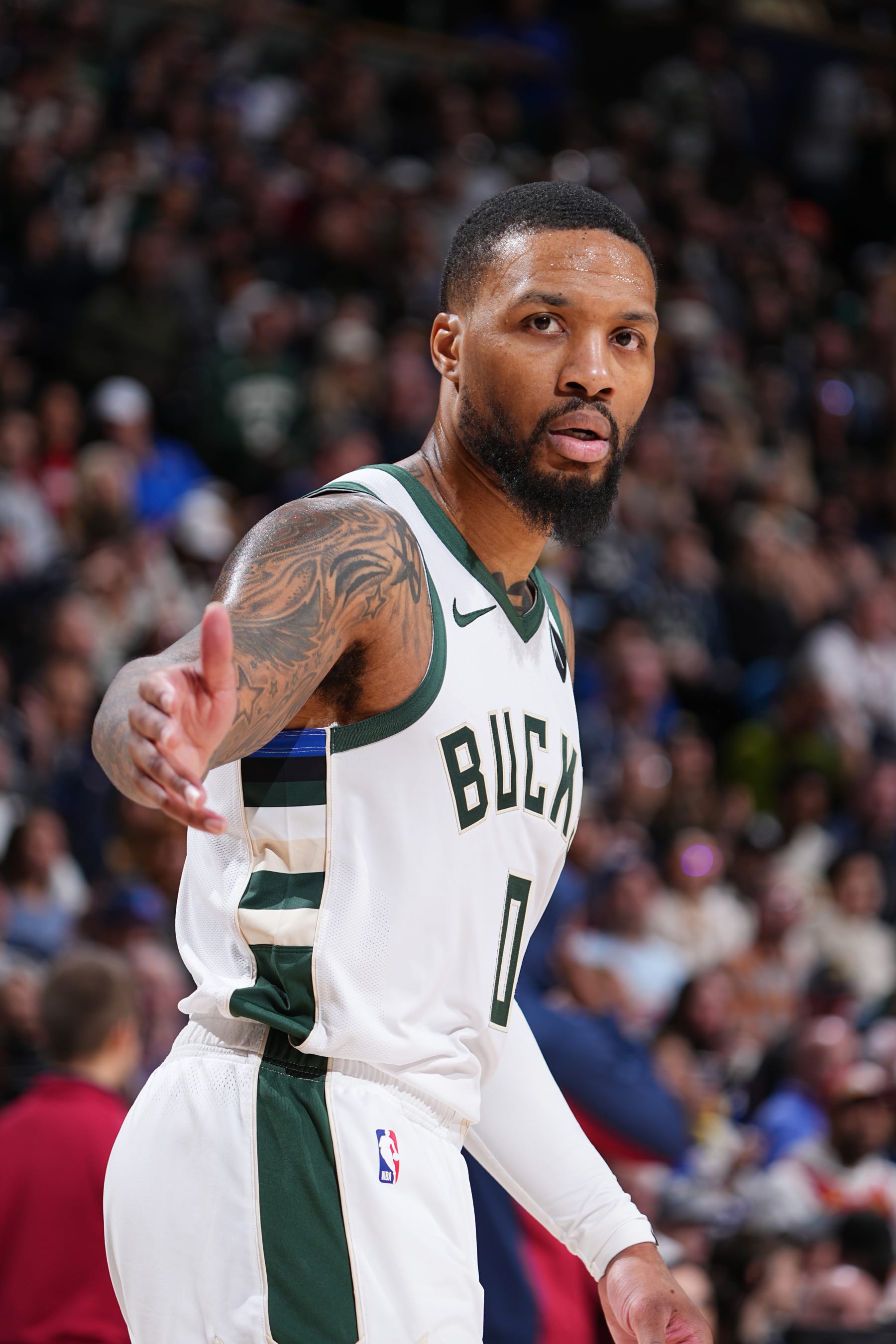 DENVER, CO - JANUARY 29: Damian Lillard #0 of the Milwaukee Bucks looks on during the game against the Denver Nuggets on January 29, 2024 at the Ball Arena in Denver, Colorado. NOTE TO USER: User expressly acknowledges and agrees that, by downloading and/or using this Photograph, user is consenting to the terms and conditions of the Getty Images License Agreement. Mandatory Copyright Notice: Copyright 2024 NBAE (Photo by Garrett Ellwood/NBAE via Getty Images)