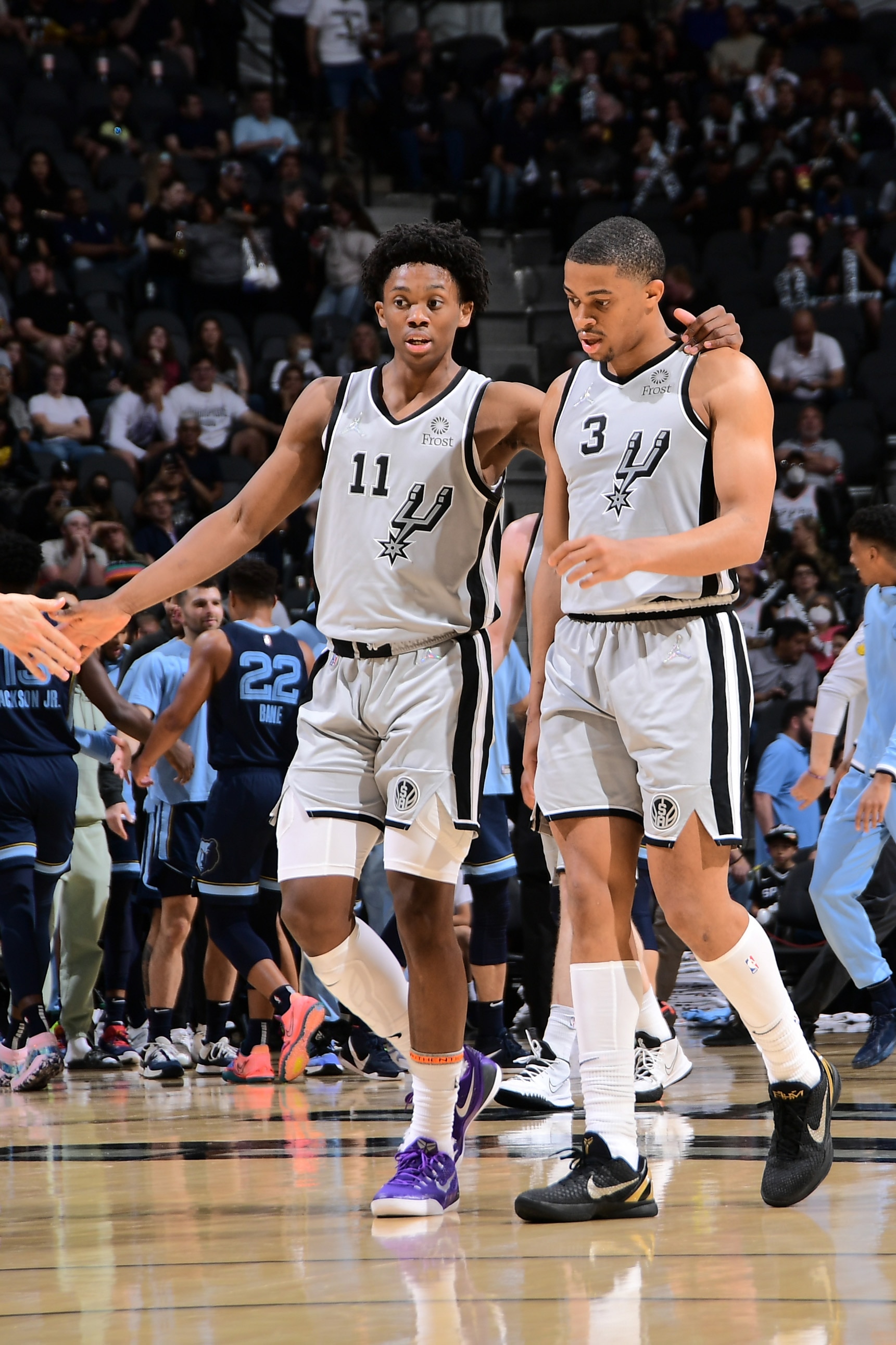 SAN ANTONIO, TX - MARCH 30: Joshua Primo #11 and Keldon Johnson #3 of the San Antonio Spurs talk during the game against the Memphis Grizzlies on March 30, 2022 at the AT&T Center in San Antonio, Texas. NOTE TO USER: User expressly acknowledges and agrees that, by downloading and or using this photograph, user is consenting to the terms and conditions of the Getty Images License Agreement. Mandatory Copyright Notice: Copyright 2022 NBAE (Photos by Michael Gonzales/NBAE via Getty Images)