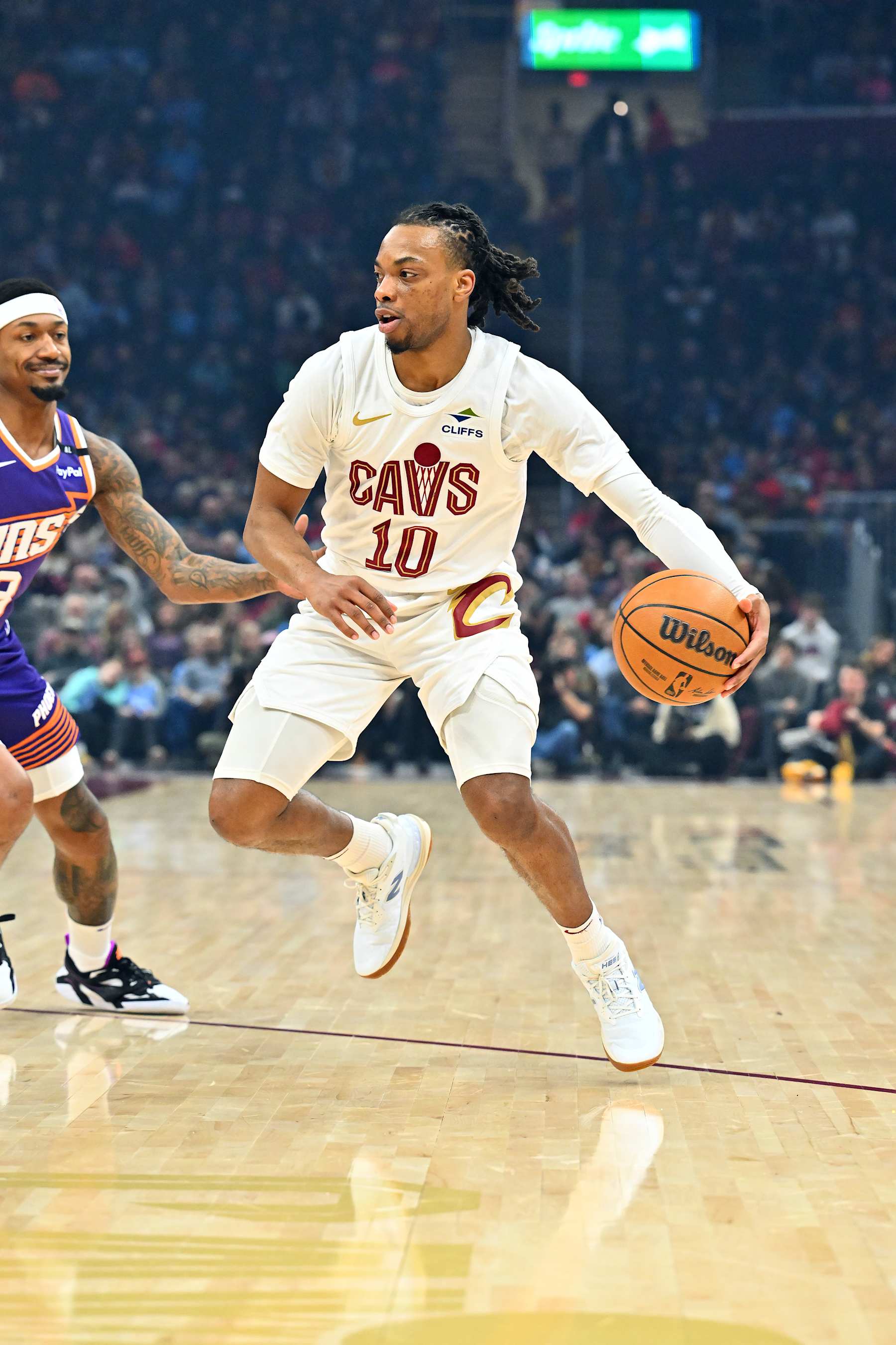 CLEVELAND, OHIO - JANUARY 20: Darius Garland #10 of the Cleveland Cavaliers drives to the basket around Bradley Beal #3 of the Phoenix Suns during the first quarter at Rocket Mortgage Fieldhouse on January 20, 2025 in Cleveland, Ohio. NOTE TO USER: User expressly acknowledges and agrees that, by downloading and or using this photograph, User is consenting to the terms and conditions of the Getty Images License Agreement. (Photo by Jason Miller/Getty Images)