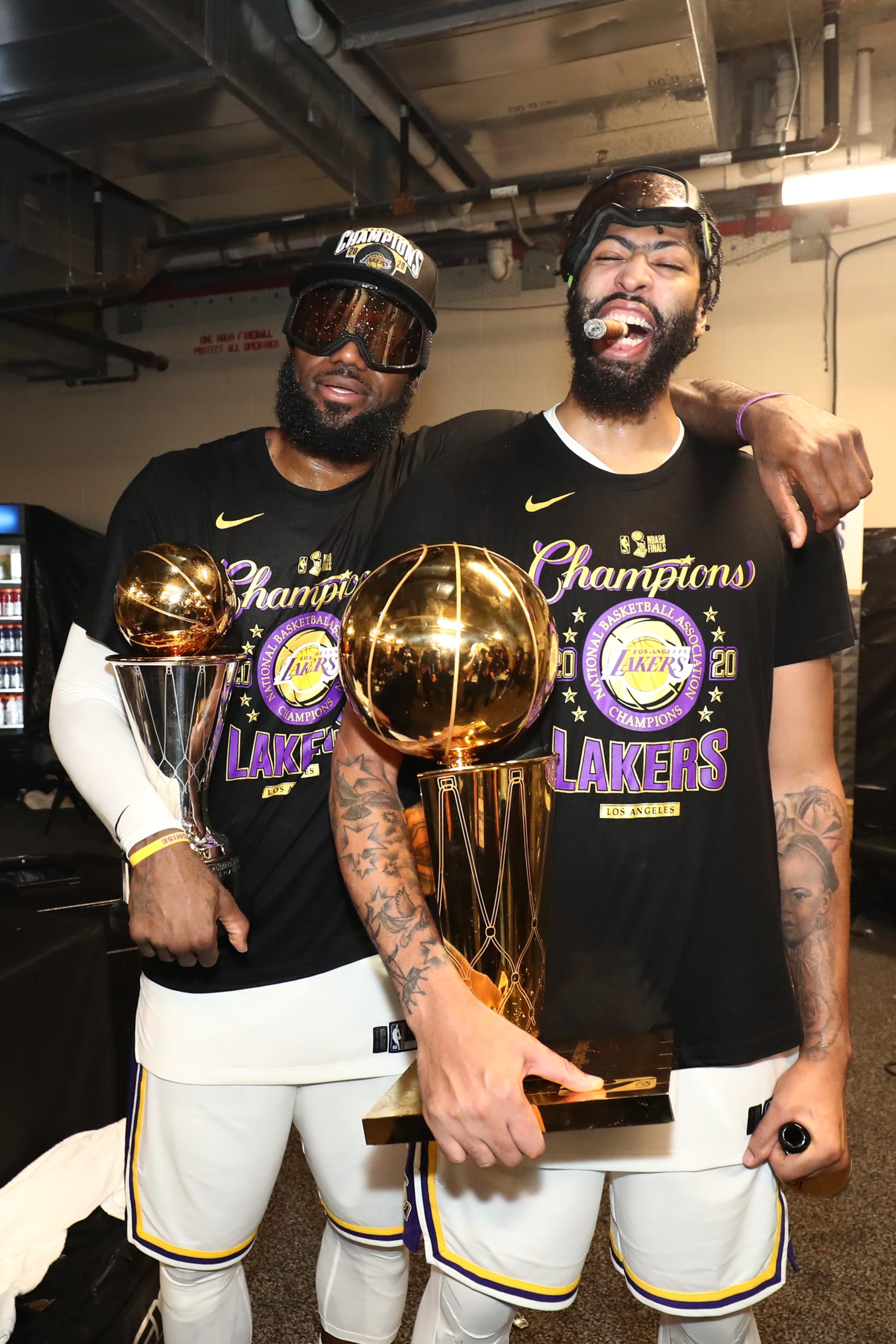 ORLANDO, FL - OCTOBER 11: LeBron James #23 and Anthony Davis #3 of the Los Angeles Lakers poses for a photo with the Larry O'Brien Trophy and The Bill Russell NBA Finals MVP Award in the locker room after winning Game Six of the NBA Finals on October 11, 2020 at AdventHealth Arena in Orlando, Florida. NOTE TO USER: User expressly acknowledges and agrees that, by downloading and/or using this Photograph, user is consenting to the terms and conditions of the Getty Images License Agreement. Mandatory Copyright Notice: Copyright 2020 NBAE (Photo by Nathaniel S. Butler/NBAE via Getty Images)