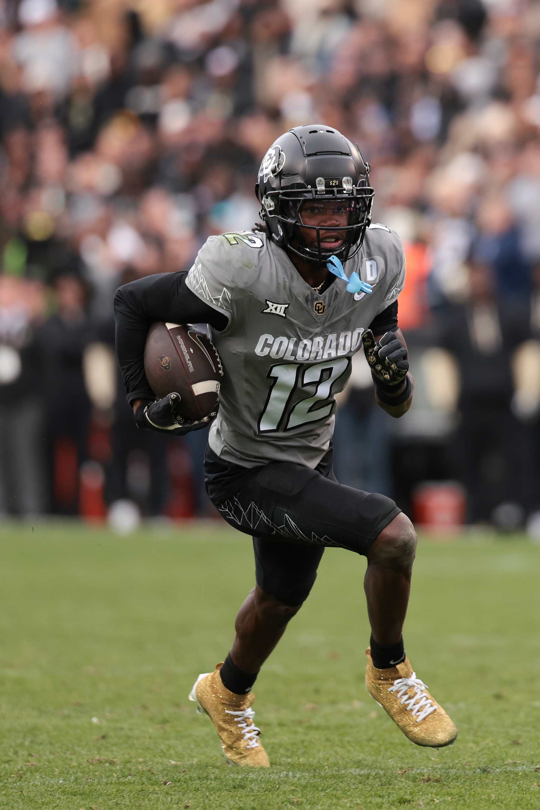 BOULDER, COLORADO - NOVEMBER 16: Travis Hunter #12 of Colorado Buffaloes runs with the ball during the fourth quarter against the Utah Utes at Folsom Field on November 16, 2024 in Boulder, Colorado. (Photo by Andrew Wevers/Getty Images)