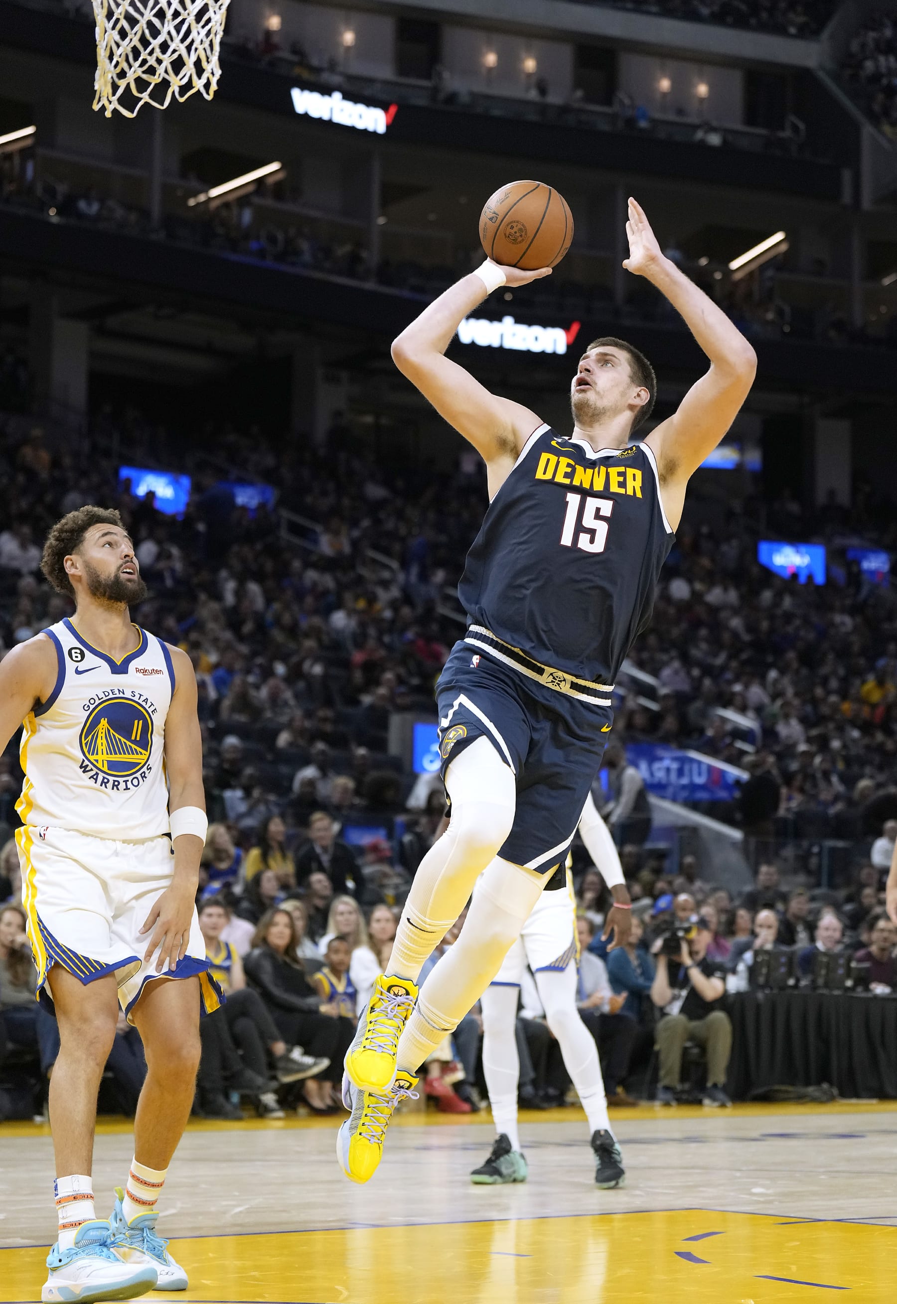 SAN FRANCISCO, CALIFORNIA - OCTOBER 14: Nikola Jokic #15 of the Denver Nuggets shoots and gets fouled by Klay Thompson #11 of the Golden State Warriors during the first half of an NBA basketball game at Chase Center on October 14, 2022 in San Francisco, California. NOTE TO USER: User expressly acknowledges and agrees that, by downloading and or using this photograph, User is consenting to the terms and conditions of the Getty Images License Agreement. (Photo by Thearon W. Henderson/Getty Images)