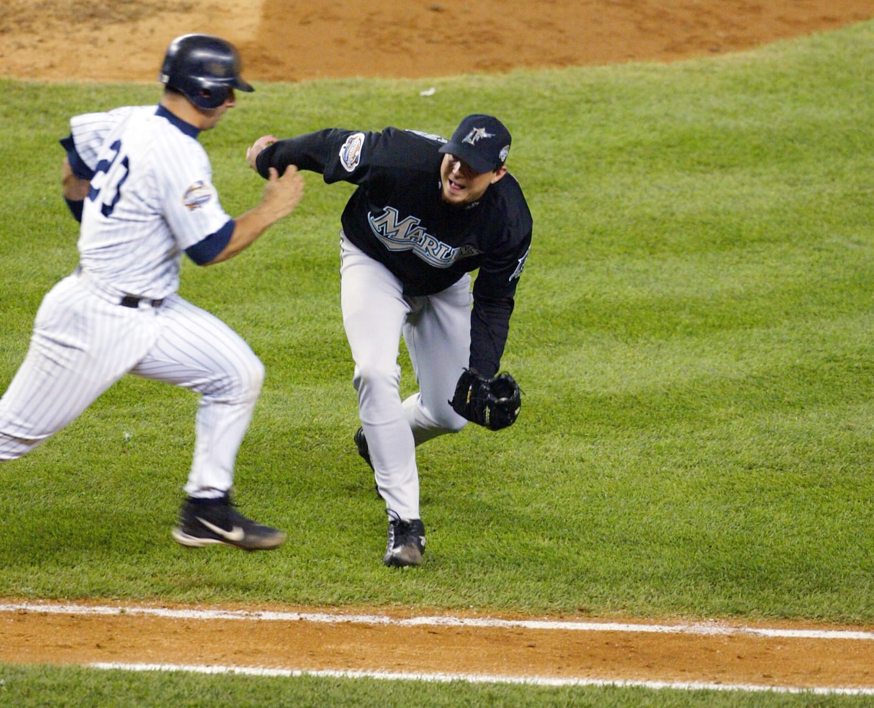 BRONX, NY - OCTOBER 25:  Pitcher Josh Beckett #21 of the Florida Marlins tags out Jorge Posada #20 of the New York Yankees to make the final out and win game six of the Major League Baseball World Series 2-0 on October 25, 2003 at Yankee Stadium in the Bronx, New York.  Beckett pitched a complete game shutout to clinch the series for the Marlins.  (Photo by Jed Jacobsohn/Getty Images)