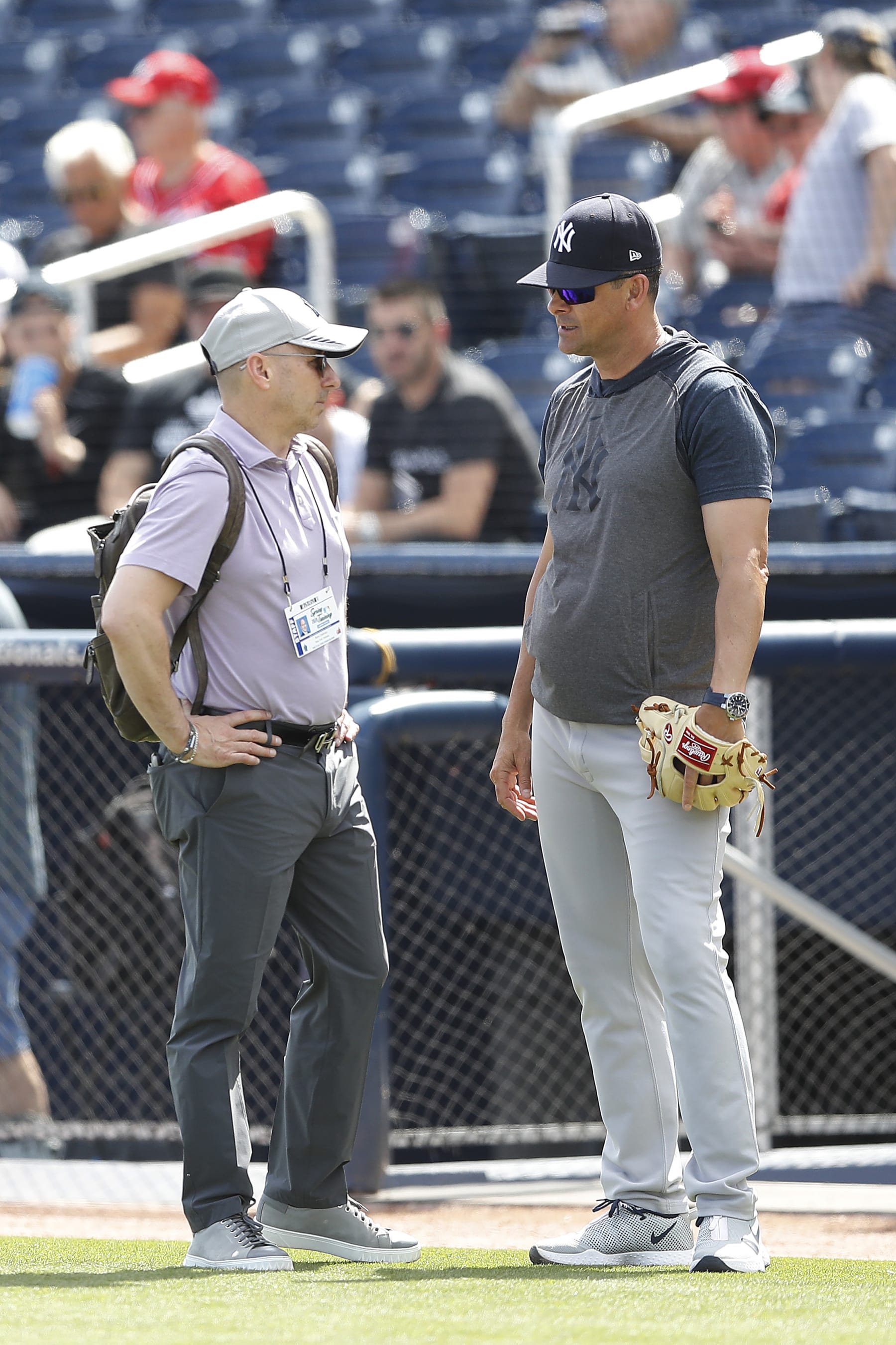 WEST PALM BEACH, FLORIDA - MARCH 12:  New York Yankees general manager Brian Cashman talks with manager Aaron Boone prior to a Grapefruit League spring training game against the Washington Nationals at FITTEAM Ballpark of The Palm Beaches on March 12, 2020 in West Palm Beach, Florida. Many professional and college sports are canceling or postponing their games due to the ongoing threat of the Coronavirus (COVID-19) outbreak. (Photo by Michael Reaves/Getty Images)