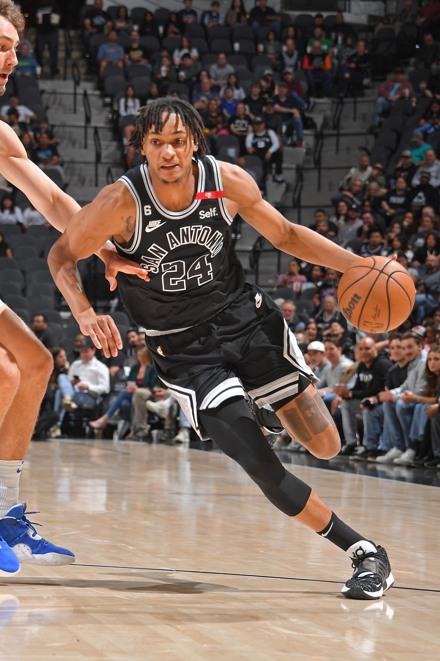 SAN ANTONIO, TX - MARCH 14: Devin Vassell #24 of the San Antonio Spurs dribbles the ball during the game against the Orlando Magic on March 14, 2023 at the AT&T Center in San Antonio, Texas. NOTE TO USER: User expressly acknowledges and agrees that, by downloading and or using this photograph, user is consenting to the terms and conditions of the Getty Images License Agreement. Mandatory Copyright Notice: Copyright 2023 NBAE (Photos by Michael Gonzales/NBAE via Getty Images)