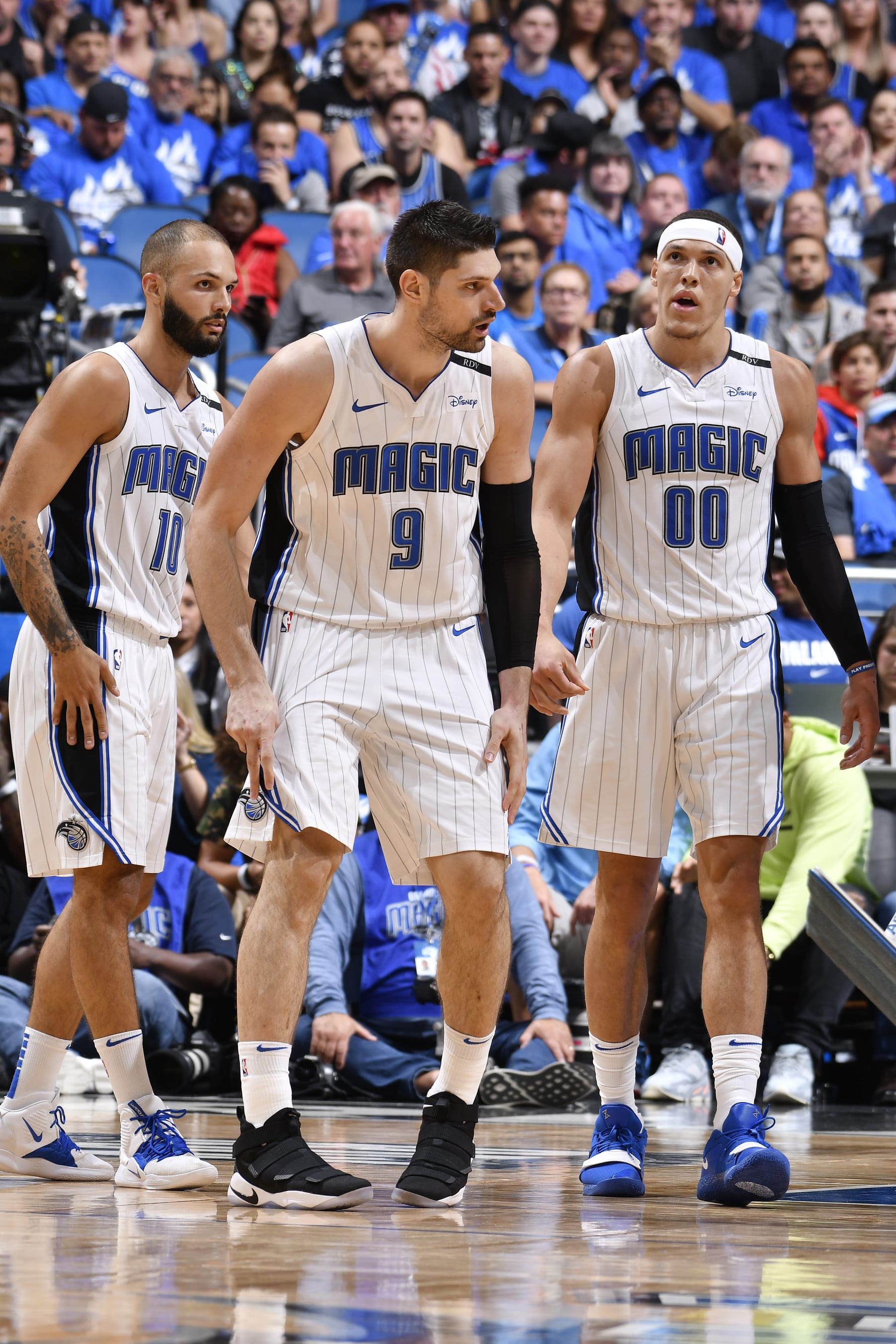 ORLANDO, FL - APRIL 19: Evan Fournier #10 Nikola Vucevic #9 and Aaron Gordon #00 of the Orlando Magic look on against the Toronto Raptors during Game Three of Round One of the 2019 NBA Playoffs on April 19, 2019 at Amway Center in Orlando, Florida. NOTE TO USER: User expressly acknowledges and agrees that, by downloading and or using this photograph, User is consenting to the terms and conditions of the Getty Images License Agreement. Mandatory Copyright Notice: Copyright 2019 NBAE (Photo by Fernando Medina/NBAE via Getty Images)