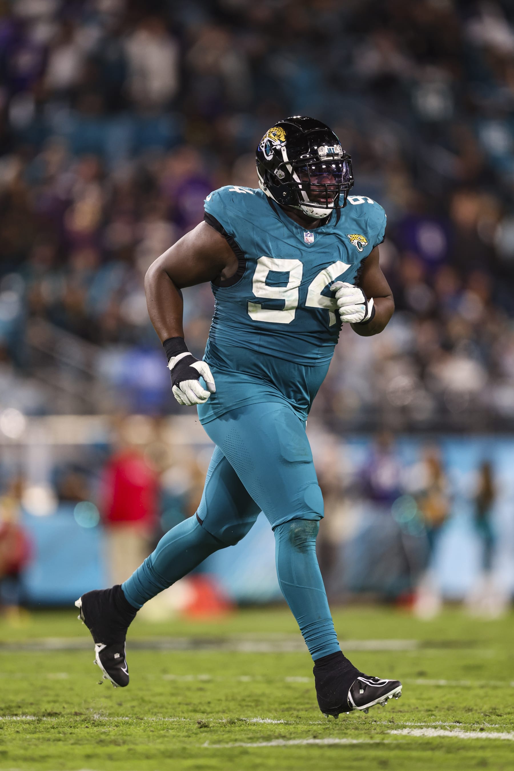 JACKSONVILLE, FL - DECEMBER 17: Folorunso Fatukasi #94 of the Jacksonville Jaguars runs across the field during an NFL football game against the Baltimore Ravens at EverBank Stadium on December 17, 2023 in Jacksonville, Florida. (Photo by Perry Knotts/Getty Images)