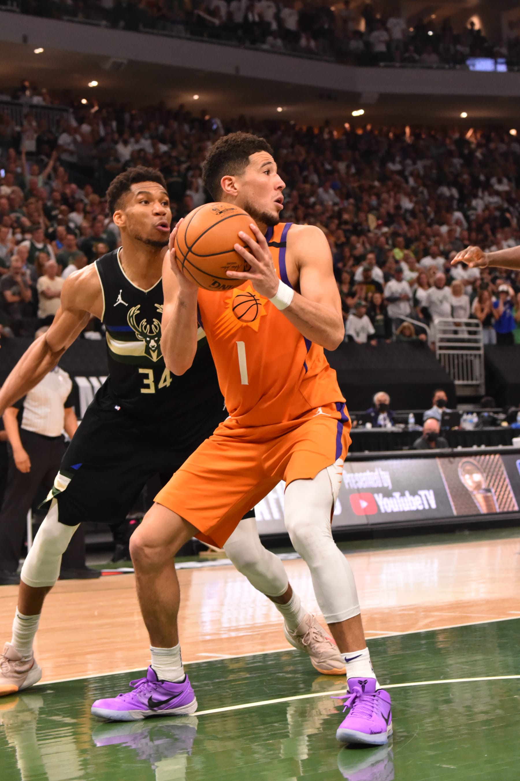 MILWAUKEE, WI - JULY 20: Devin Booker #1 of the Phoenix Suns handles the ball against Giannis Antetokounmpo #34 of the Milwaukee Bucks during Game Six of the 2021 NBA Finals on July 20, 2021 at Fiserv Forum in Milwaukee, Wisconsin. NOTE TO USER: User expressly acknowledges and agrees that, by downloading and/or using this Photograph, user is consenting to the terms and conditions of the Getty Images License Agreement. Mandatory Copyright Notice: Copyright 2021 NBAE (Photo by Jesse D. Garrabrant/NBAE via Getty Images)