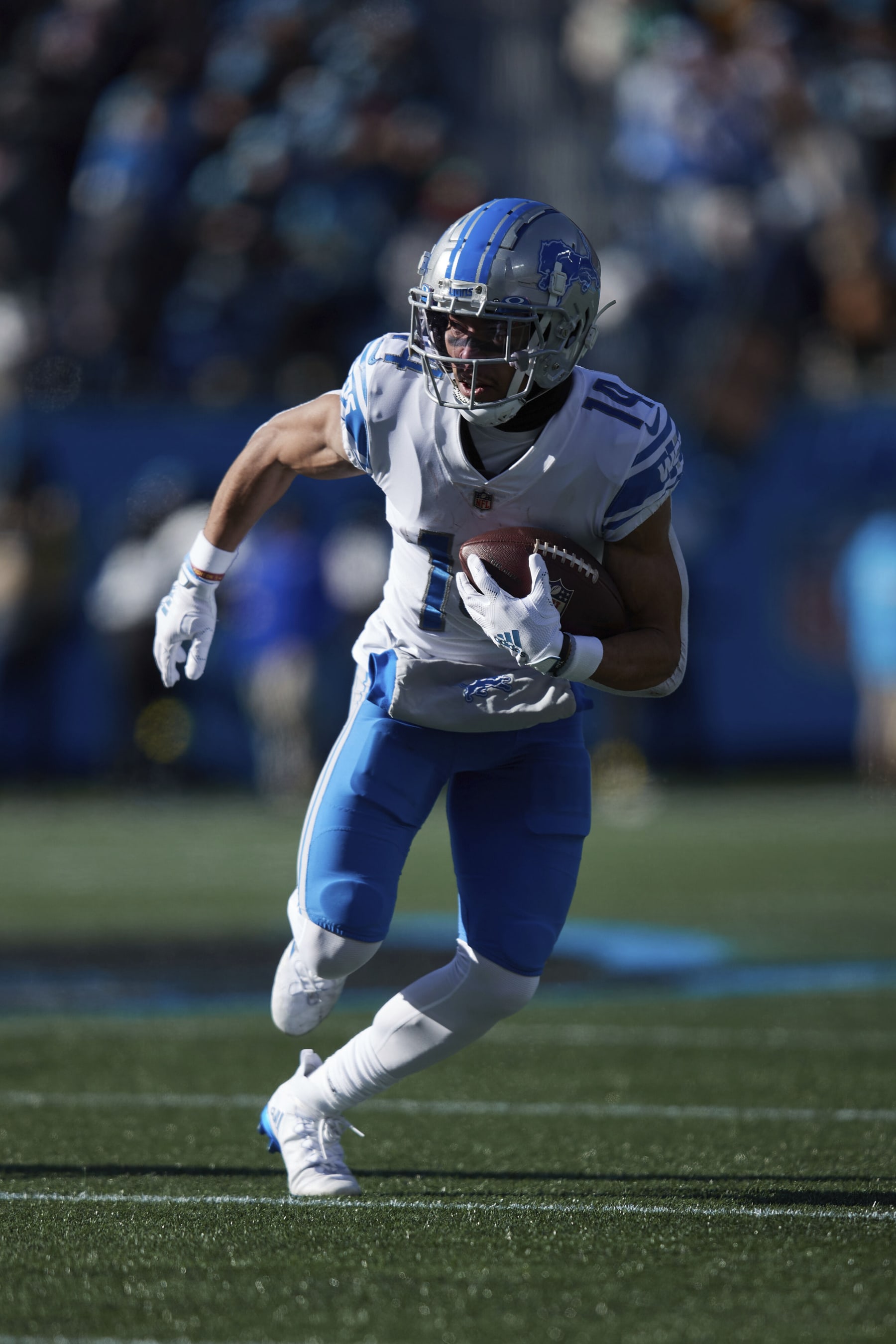 Detroit Lions wide receiver Amon-Ra St. Brown (14) runs with the ball after catching a pass during an NFL football game against the Carolina Panthers, Saturday, Dec. 24, 2022, in Charlotte, N.C. (AP Photo/Brian Westerholt)