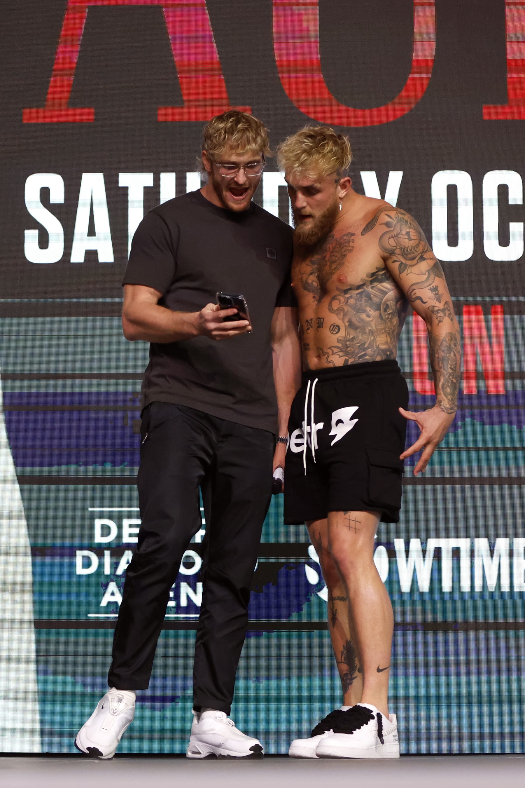 GLENDALE, ARIZONA - OCTOBER 28: Jake Paul (R) talks to his brother Logan Paul after his official weigh in at Desert Diamond Arena on October 28, 2022 in Glendale, Arizona. (Photo by Chris Coduto/Getty Images)