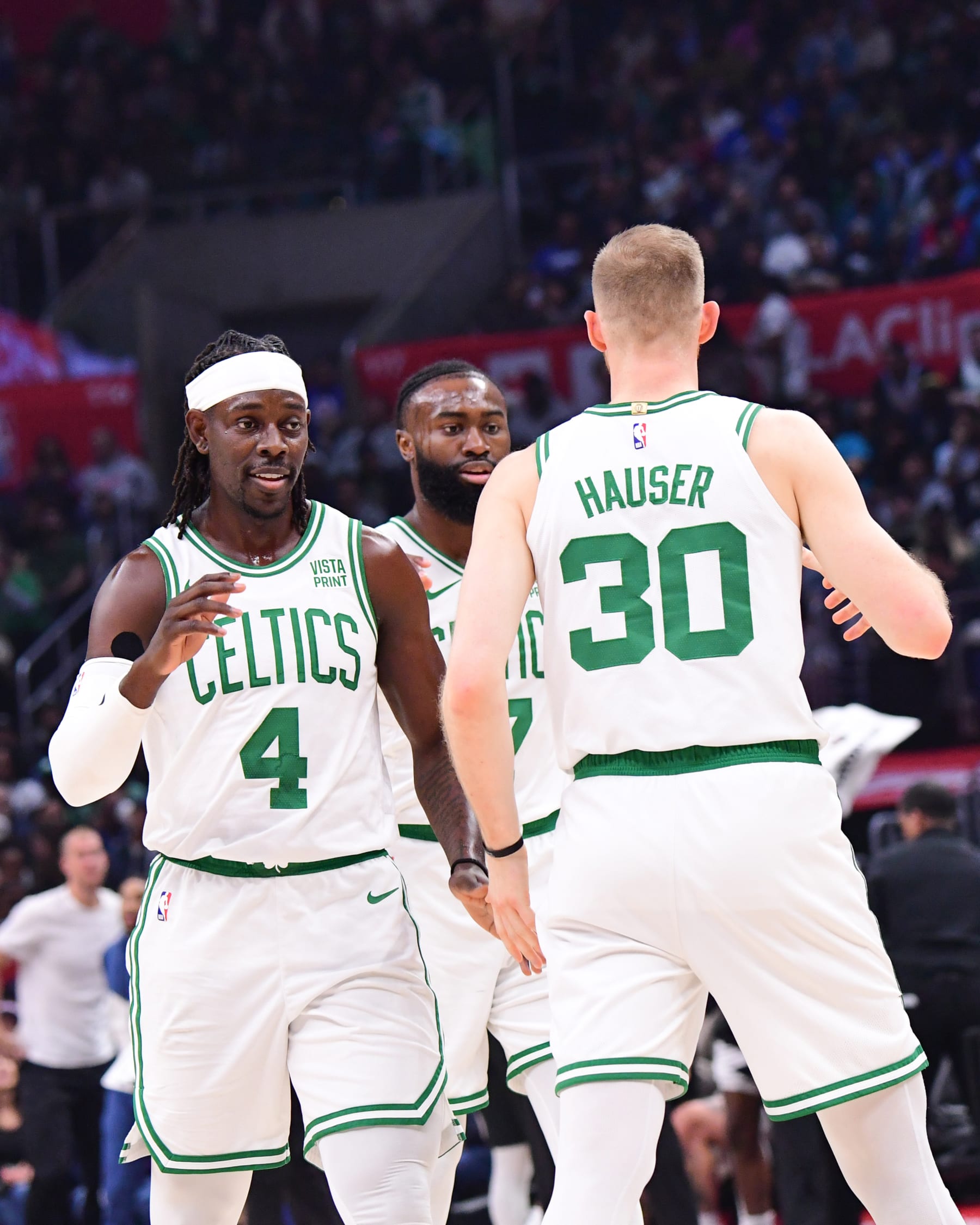 LOS ANGELES, CA - DECEMBER 23:  Jrue Holiday #4 of the Boston Celtics Jaylen Brown #7 of the Boston Celtics & Sam Hauser #30 of the Boston Celtics high five during the game  on December 23, 2023 at Crypto.Com Arena in Los Angeles, California. NOTE TO USER: User expressly acknowledges and agrees that, by downloading and/or using this Photograph, user is consenting to the terms and conditions of the Getty Images License Agreement. Mandatory Copyright Notice: Copyright 2023 NBAE (Photo by Adam Pantozzi/NBAE via Getty Images)