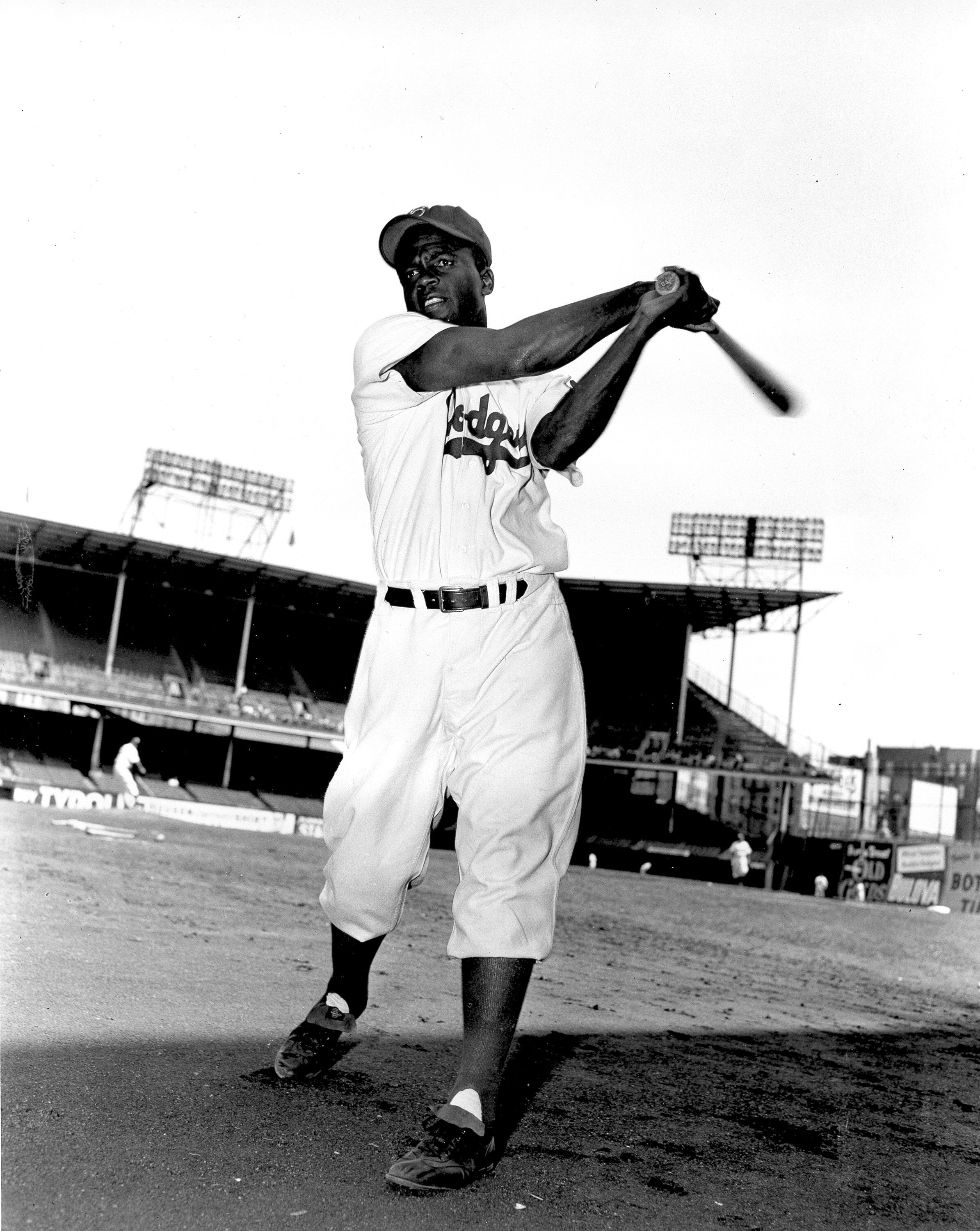 FILE - Jackie Robinson, infielder for the Brooklyn Dodgers, swings his bat in this action pose at Ebbett's Field in Brooklyn, N.Y., on May 9, 1951. A plaque honoring baseball legend Jackie Robinson that was vandalized in Georgia is coming to Kansas City's Negro Leagues Baseball Museum to be put on display. The sign was erected in 2001 outside the birthplace of Robinson near Cairo, Georgia. Community members there discovered last year that someone had shot the plaque multiple times. (AP Photo File)