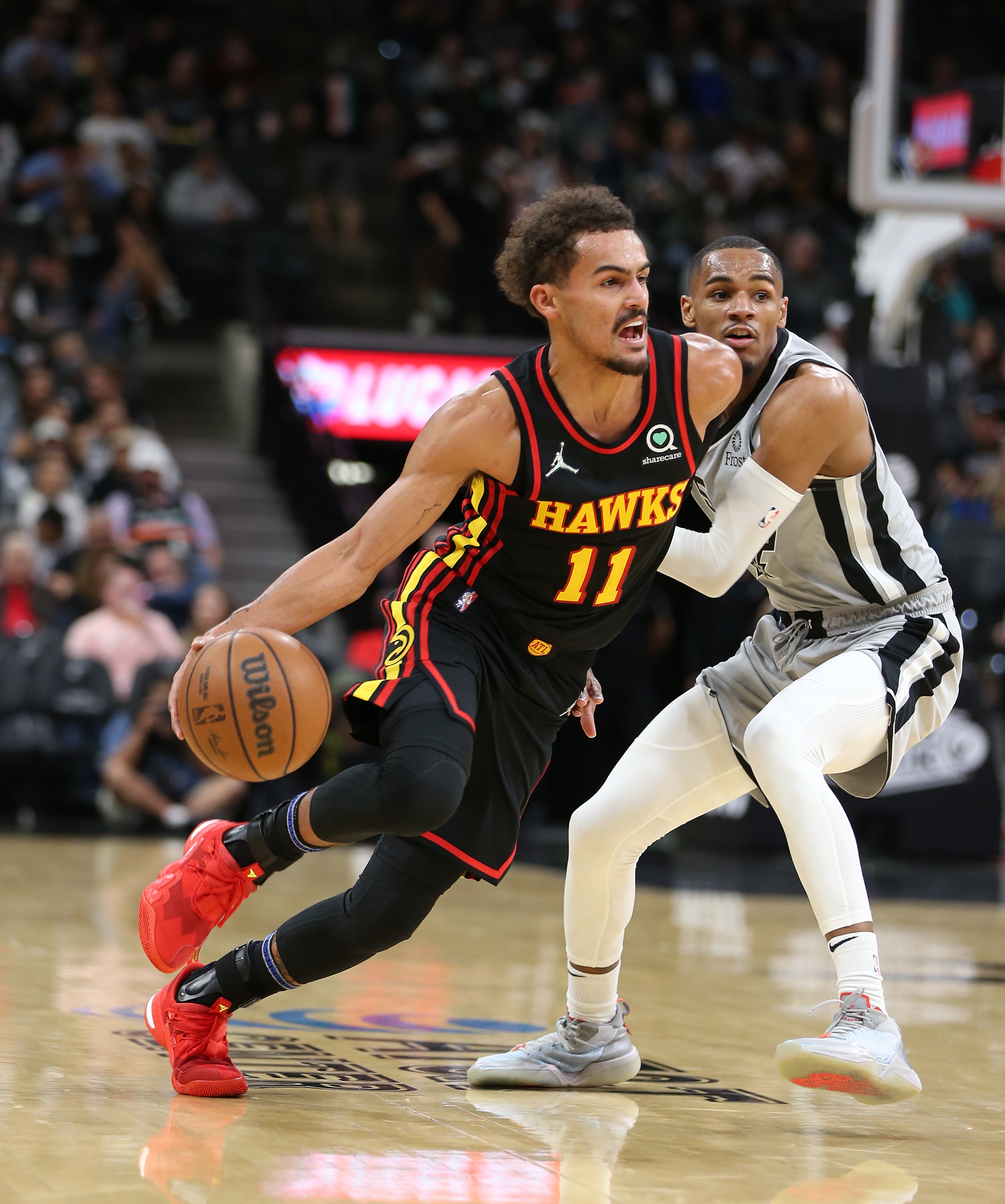 SAN ANTONIO, TX - NOVEMBER 24:  Trae Young #11 of the Atlanta Hawks drives past Dejounte Murray #5 of the San Antonio Spurs at AT&T Center on November 24, 2021 in San Antonio, Texas.  NOTE TO USER: User expressly acknowledges and agrees that , by downloading and or using this photograph, User is consenting to the terms and conditions of the Getty Images License Agreement. (Photo by Ronald Cortes/Getty Images)