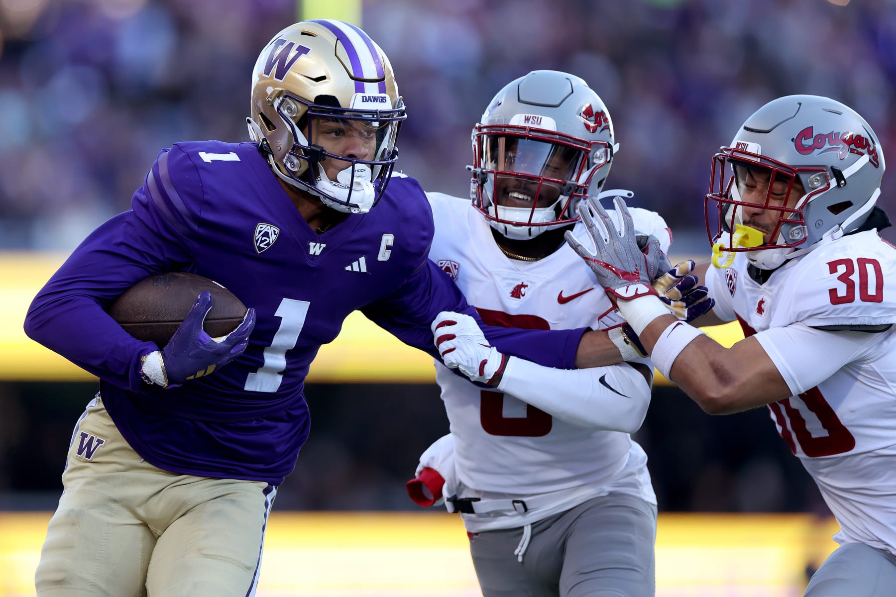 SEATTLE, WASHINGTON - NOVEMBER 25: Rome Odunze #1 of the Washington Huskies catches the ball against Cam Lampkin #3 of the Washington State Cougars and Jackson Lataimua #30 of the Washington State Cougars during the first quarter at Husky Stadium on November 25, 2023 in Seattle, Washington. (Photo by Steph Chambers/Getty Images)