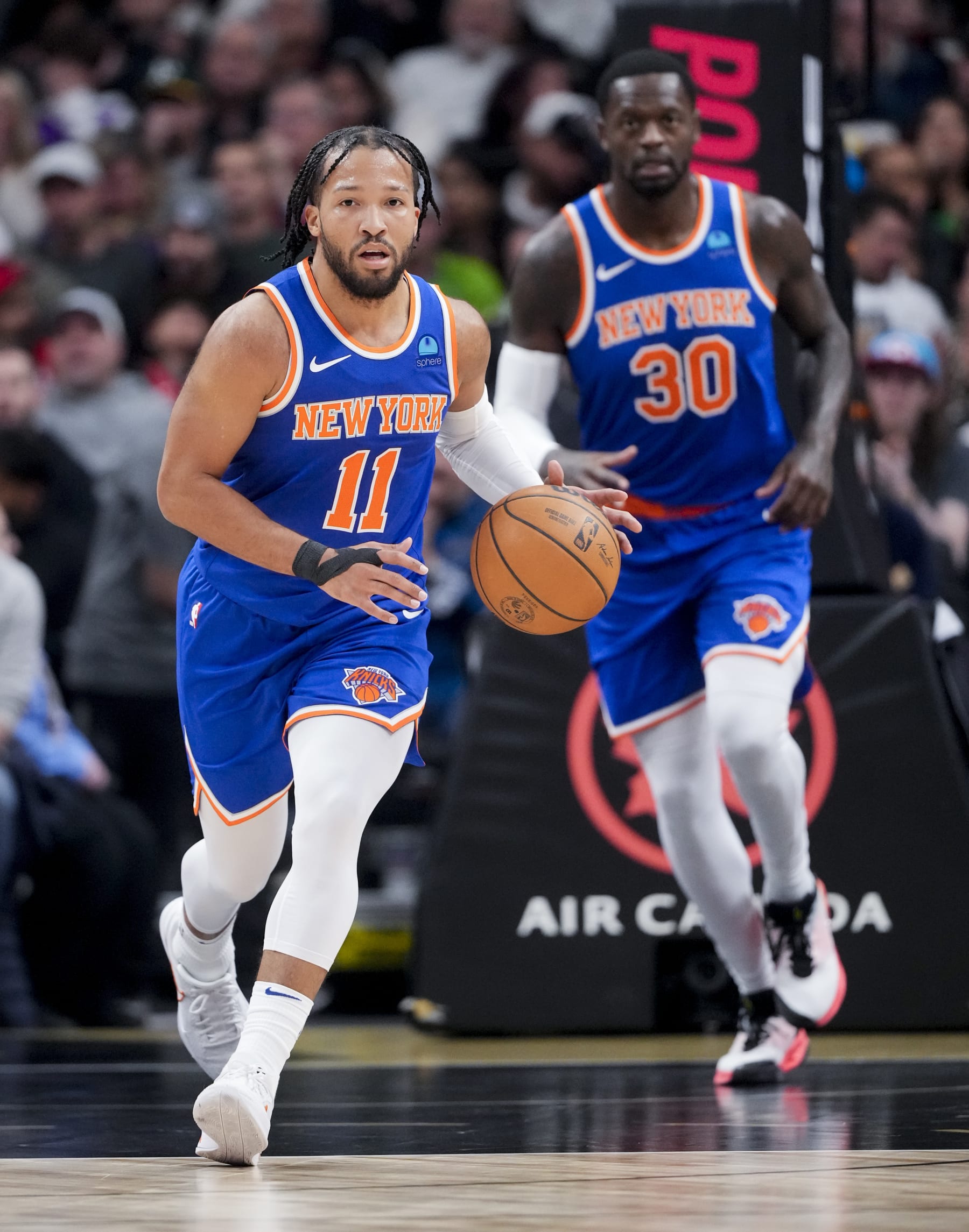 TORONTO, ON - DECEMBER 1: Jalen Brunson #11 and Julius Randle #30 of the New York Knicks bring the ball up the floor against the Toronto Raptors during the first half of their basketball game at the Scotiabank Arena on December 1, 2023 in Toronto, Ontario, Canada. NOTE TO USER: User expressly acknowledges and agrees that, by downloading and/or using this Photograph, user is consenting to the terms and conditions of the Getty Images License Agreement. (Photo by Mark Blinch/Getty Images)