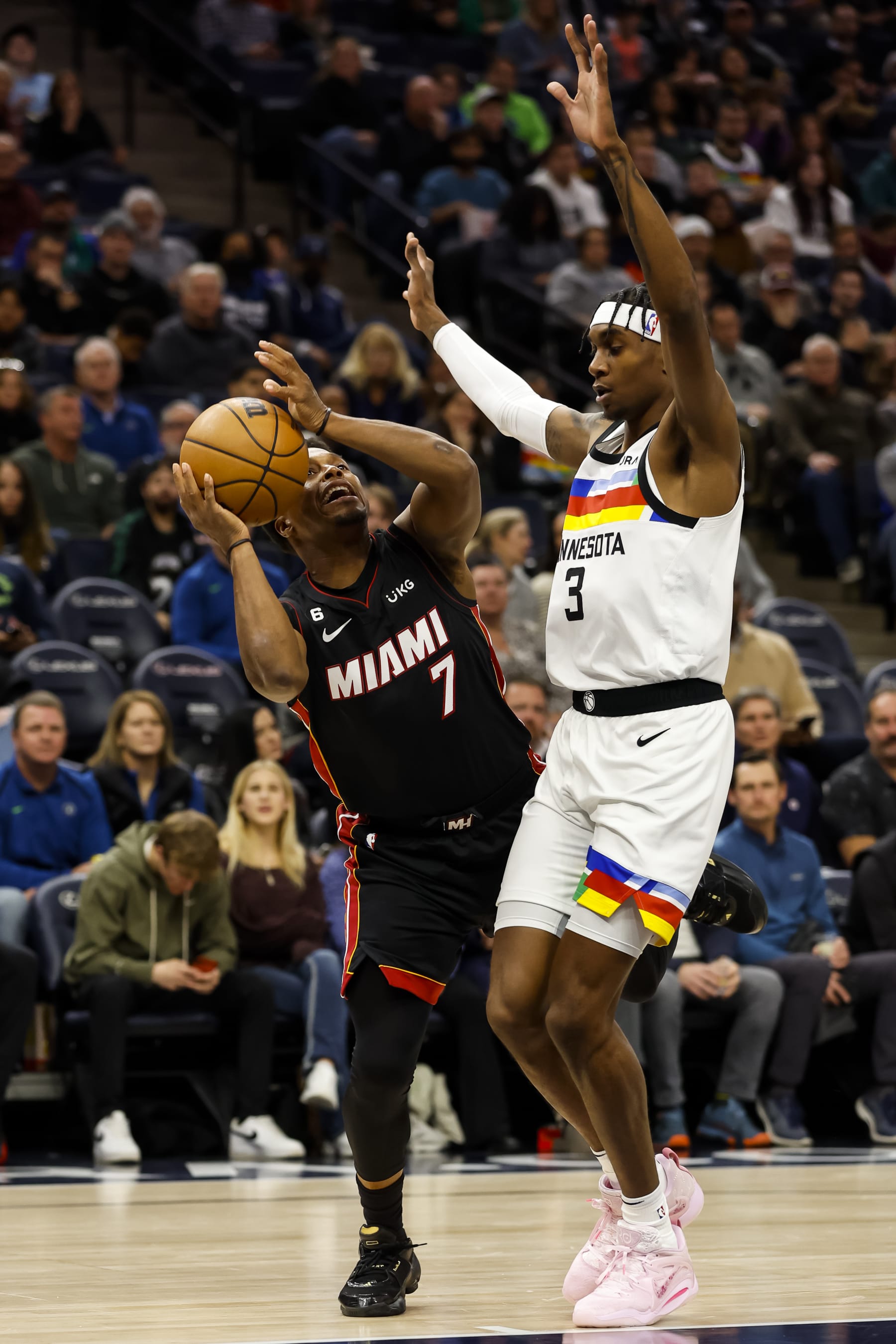 MINNEAPOLIS, MN - NOVEMBER 21: Kyle Lowry #7 of the Miami Heat is fouled by Jaden McDaniels #3 of the Minnesota Timberwolves in the first quarter of the game at Target Center on November 21, 2022 in Minneapolis, Minnesota. NOTE TO USER: User expressly acknowledges and agrees that, by downloading and or using this Photograph, user is consenting to the terms and conditions of the Getty Images License Agreement. (Photo by David Berding/Getty Images)